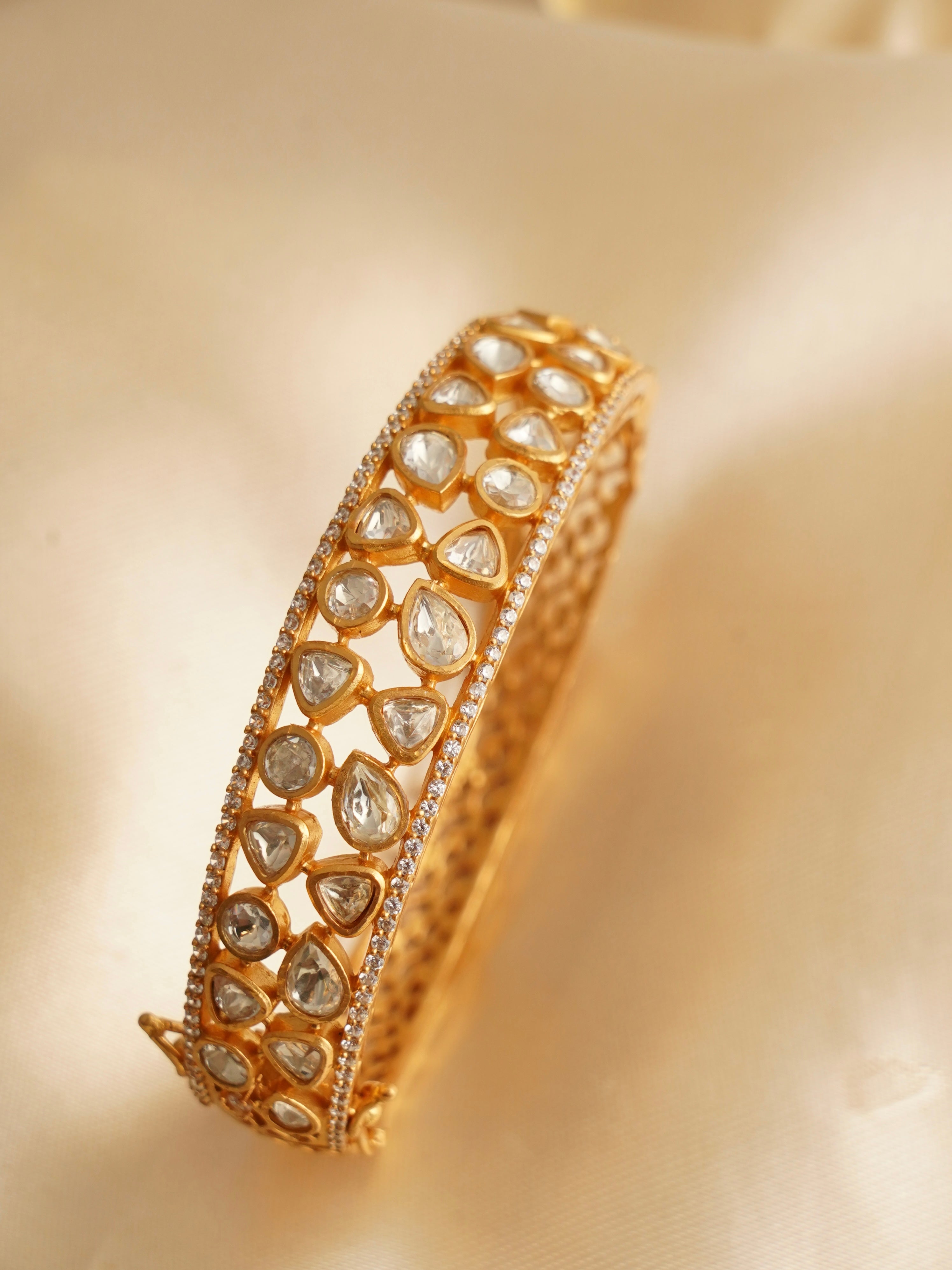 Moissanite bangle with filigree design and secure clasp in premium micron gold finish