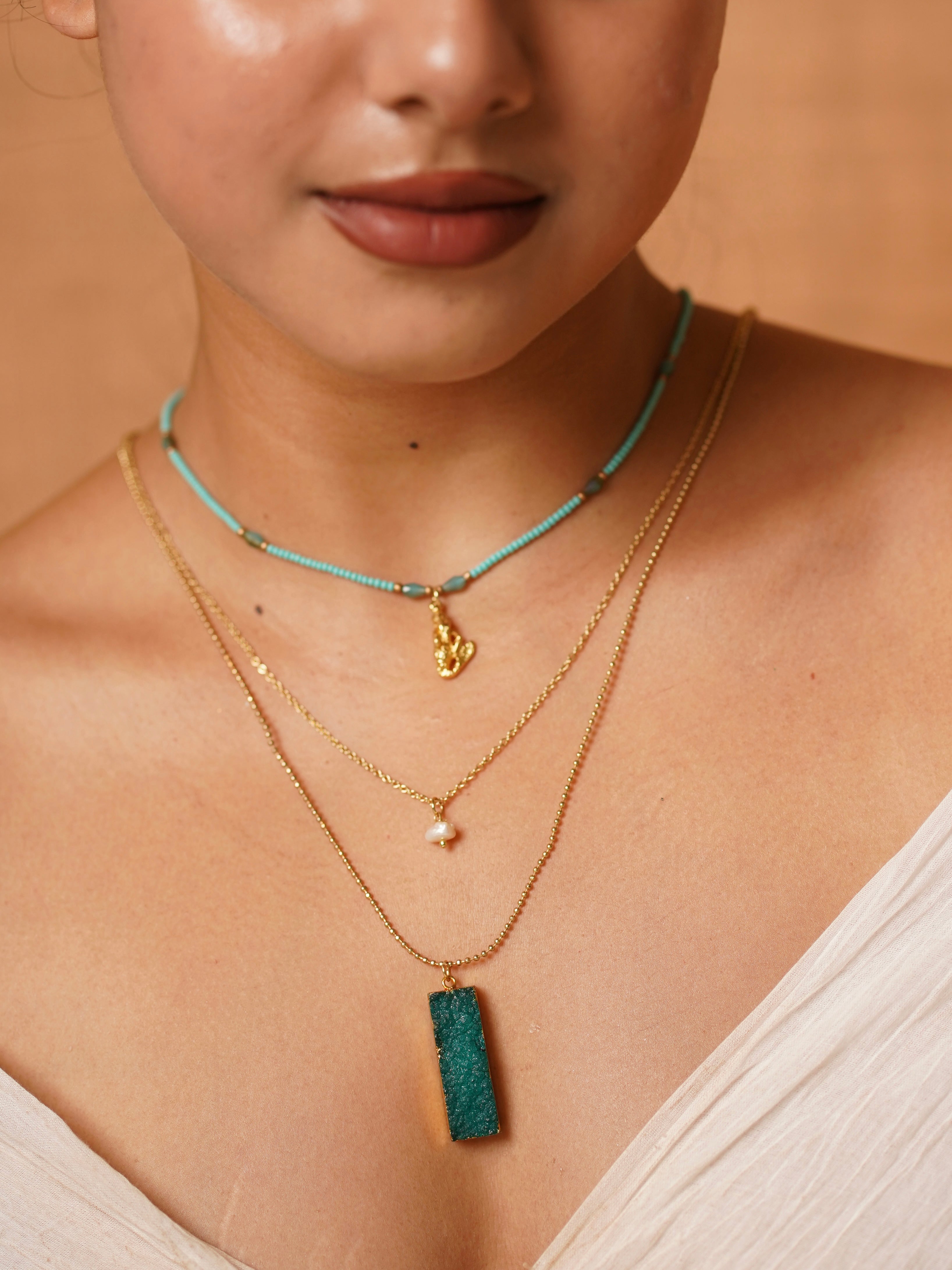 Close-up of multi-strand necklace with turquoise and natural stone details