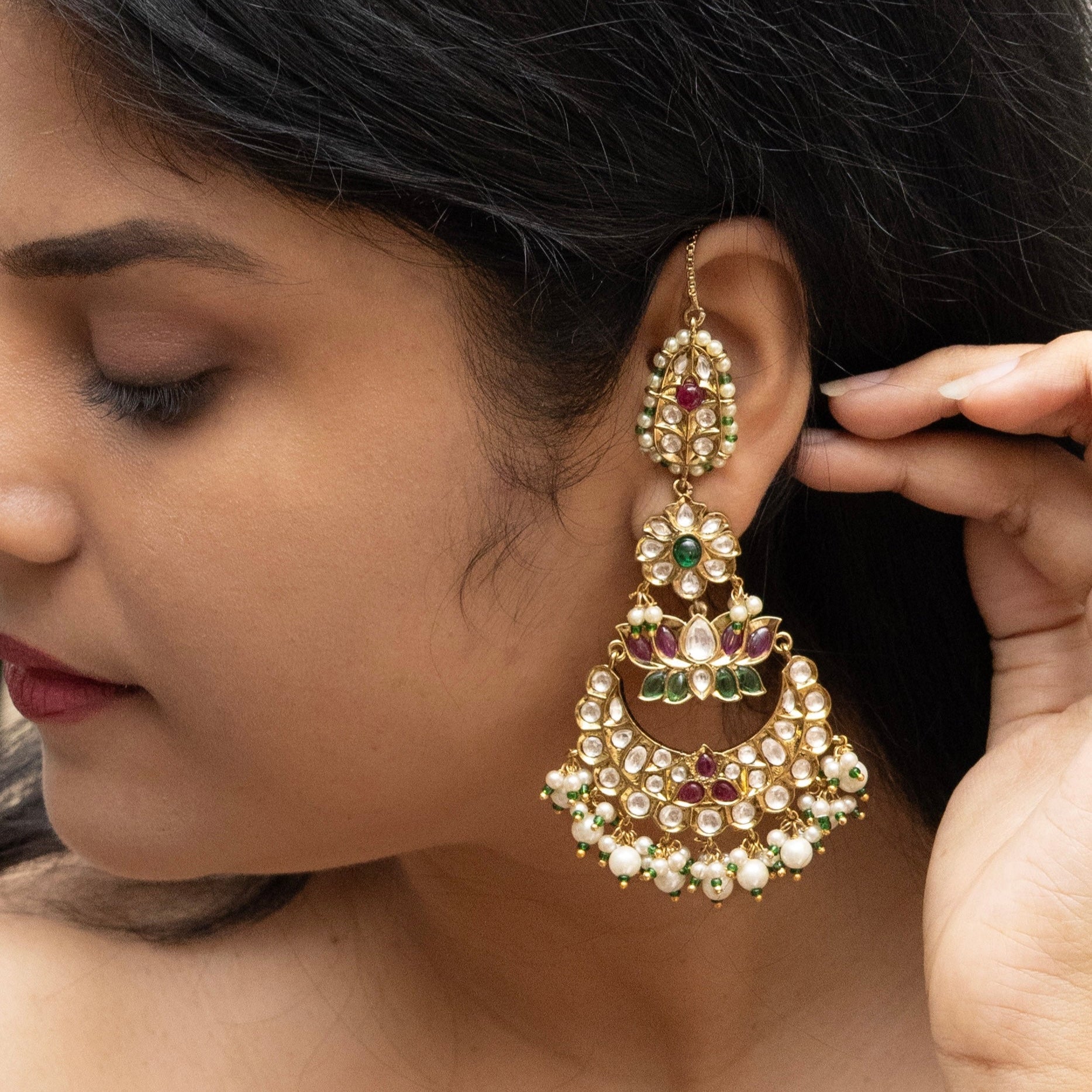 Gold-tone chandbalis with polki pearls, ruby and emerald accents, frontal view