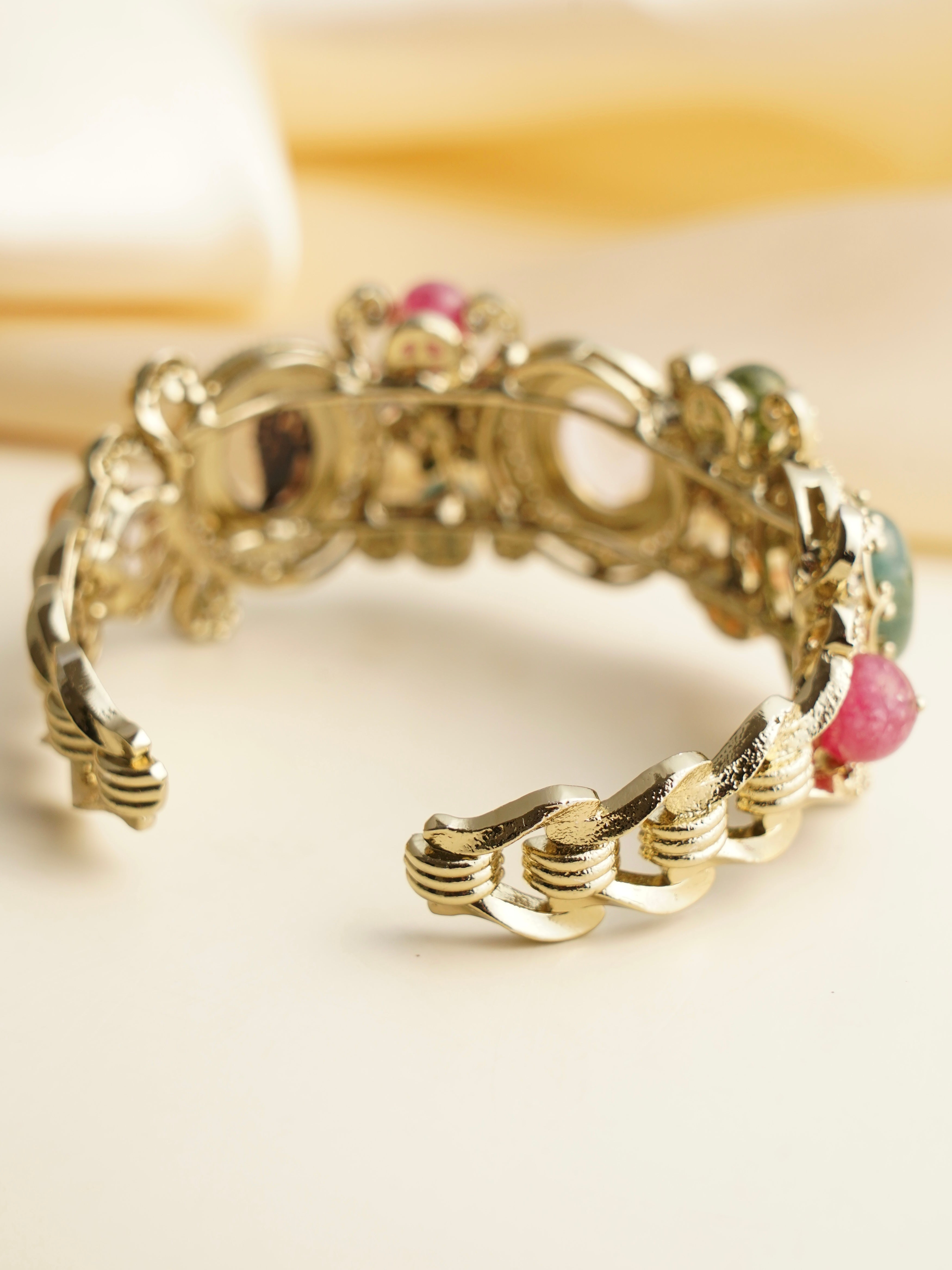 Close-up of navratna kada highlighting gemstone texture and traditional polki work