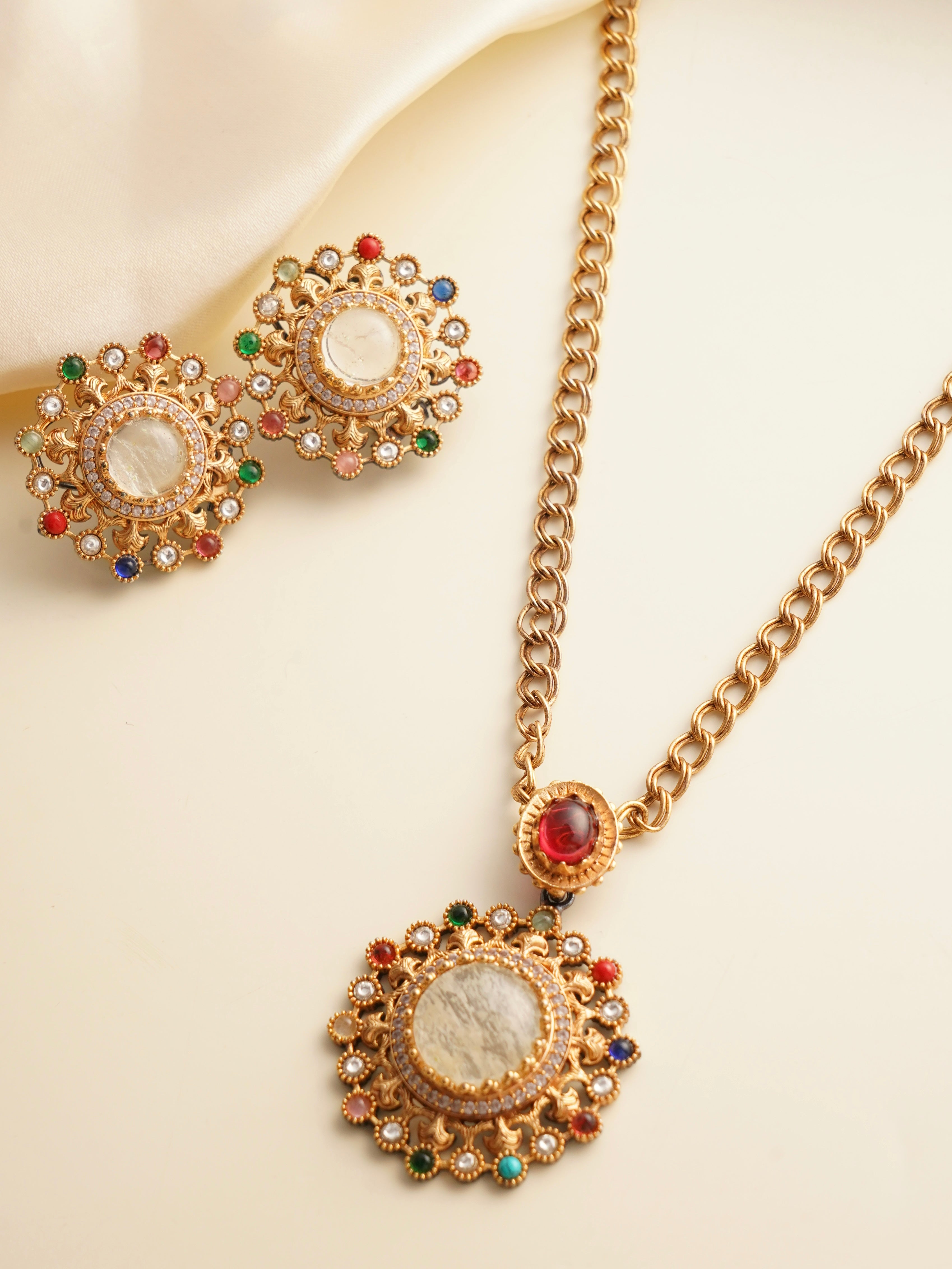 Navratna pendant set with colorful stones and gold finish, front view
