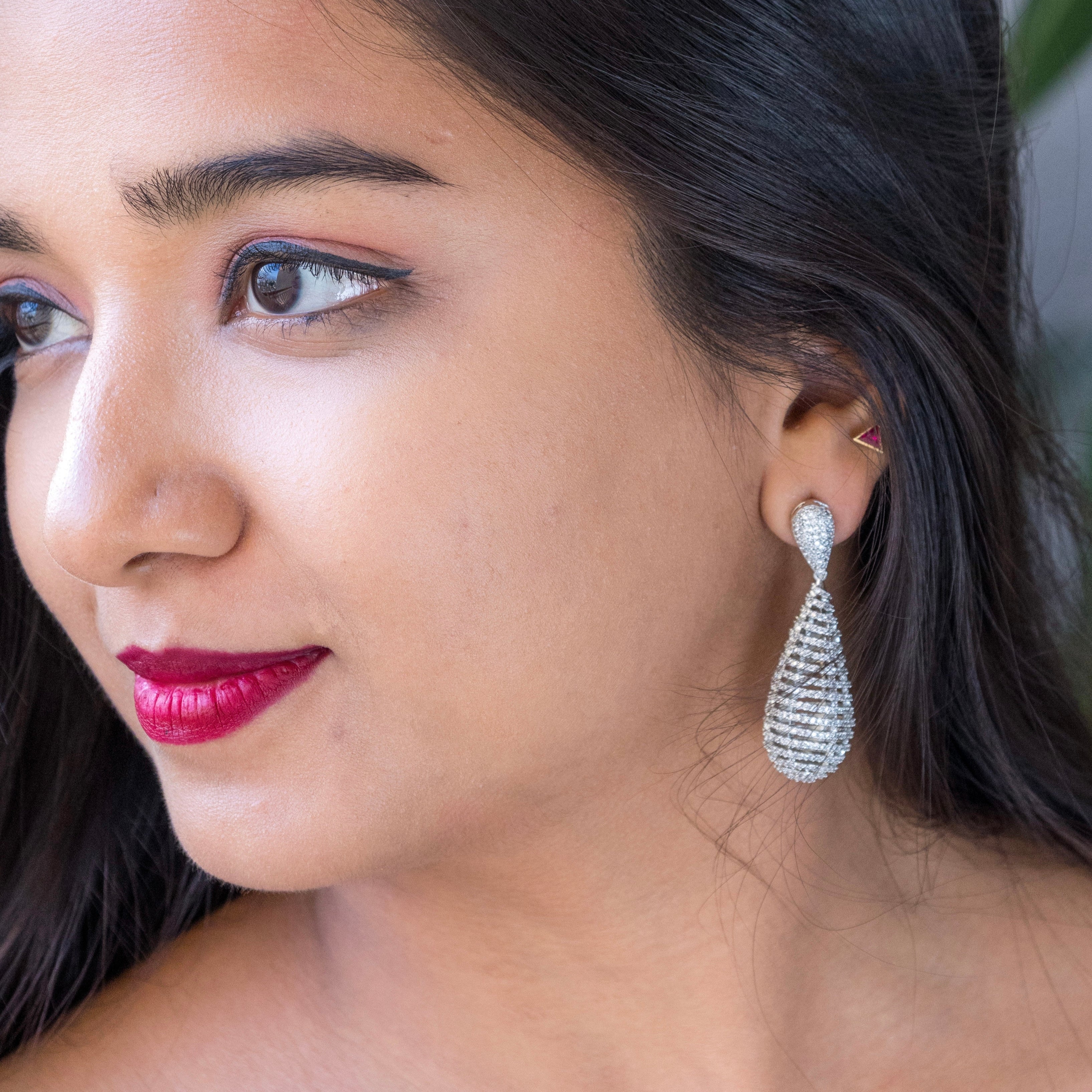 Rear view of silver diamond dangler earrings showing secure hook and metal finish