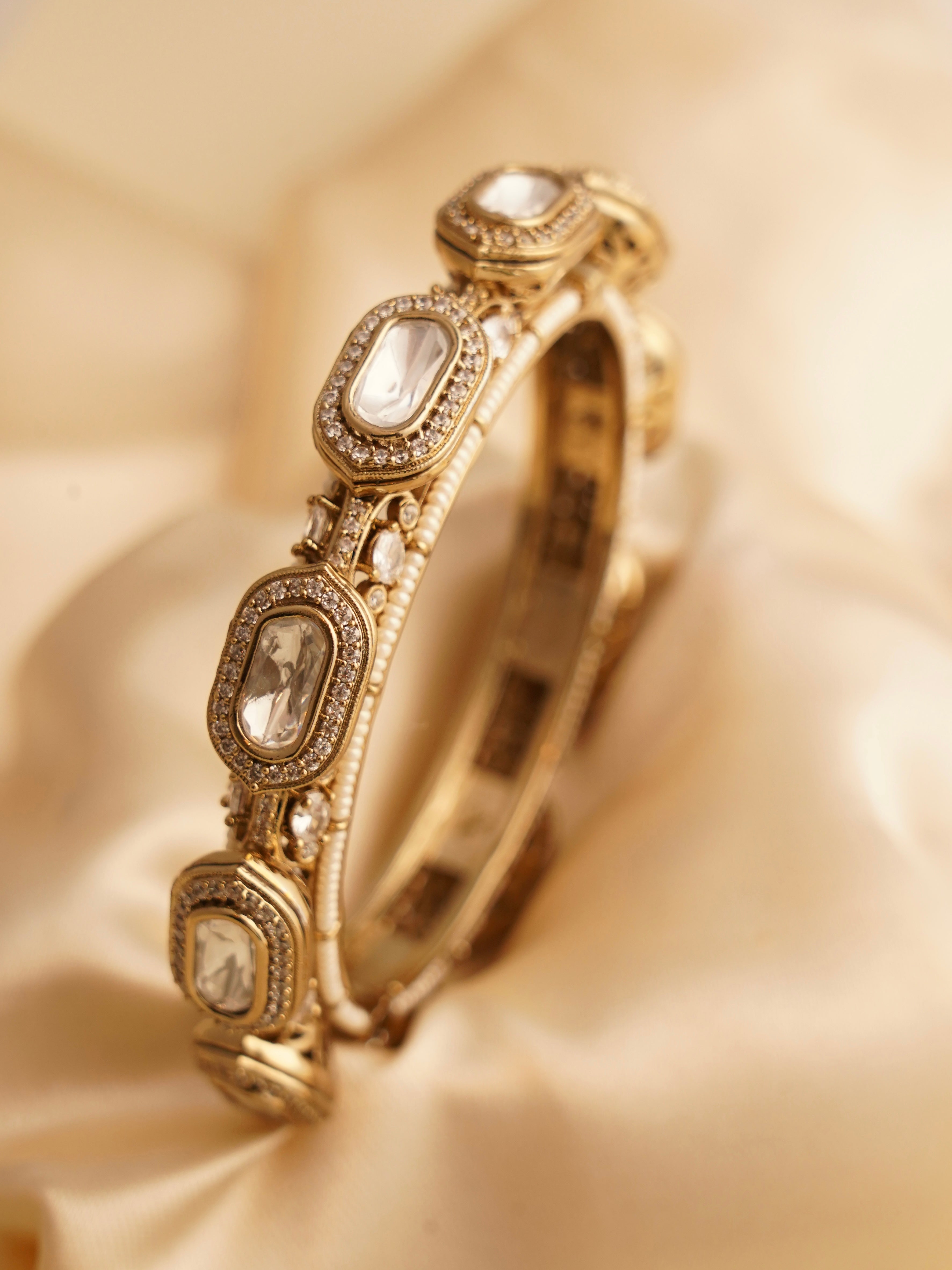 Antique gold bridal bangles with kundan and moissanite accents, top view