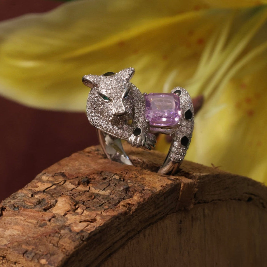 Panther-inspired ring with topaz center, emerald eyes, and shimmering pavé detailing