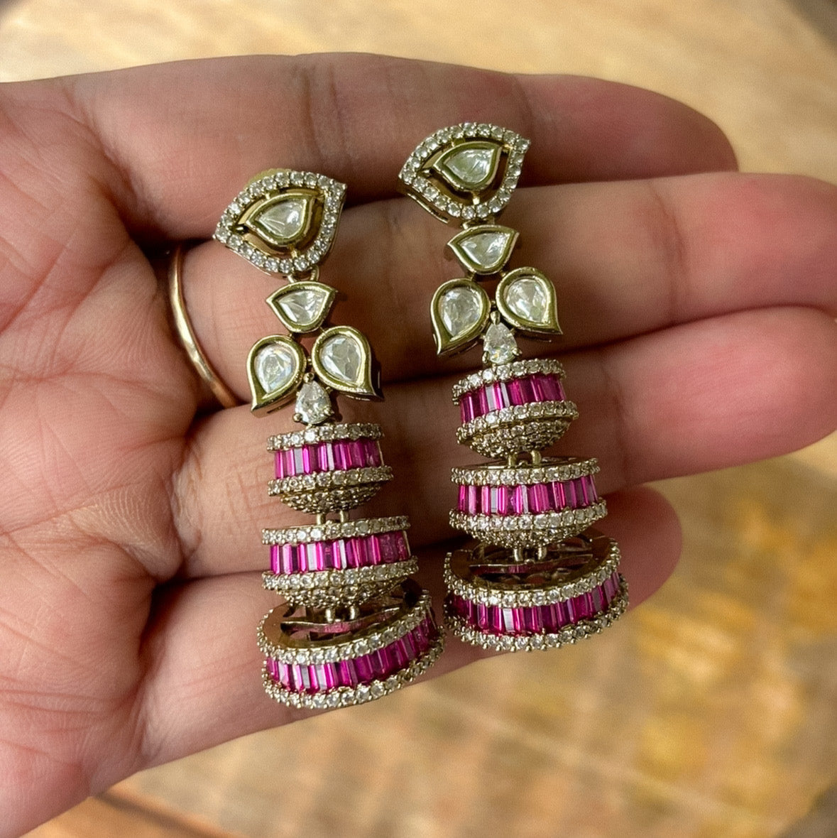 Close-up of dazzling Alina earrings with geometric baguette and crystal accents