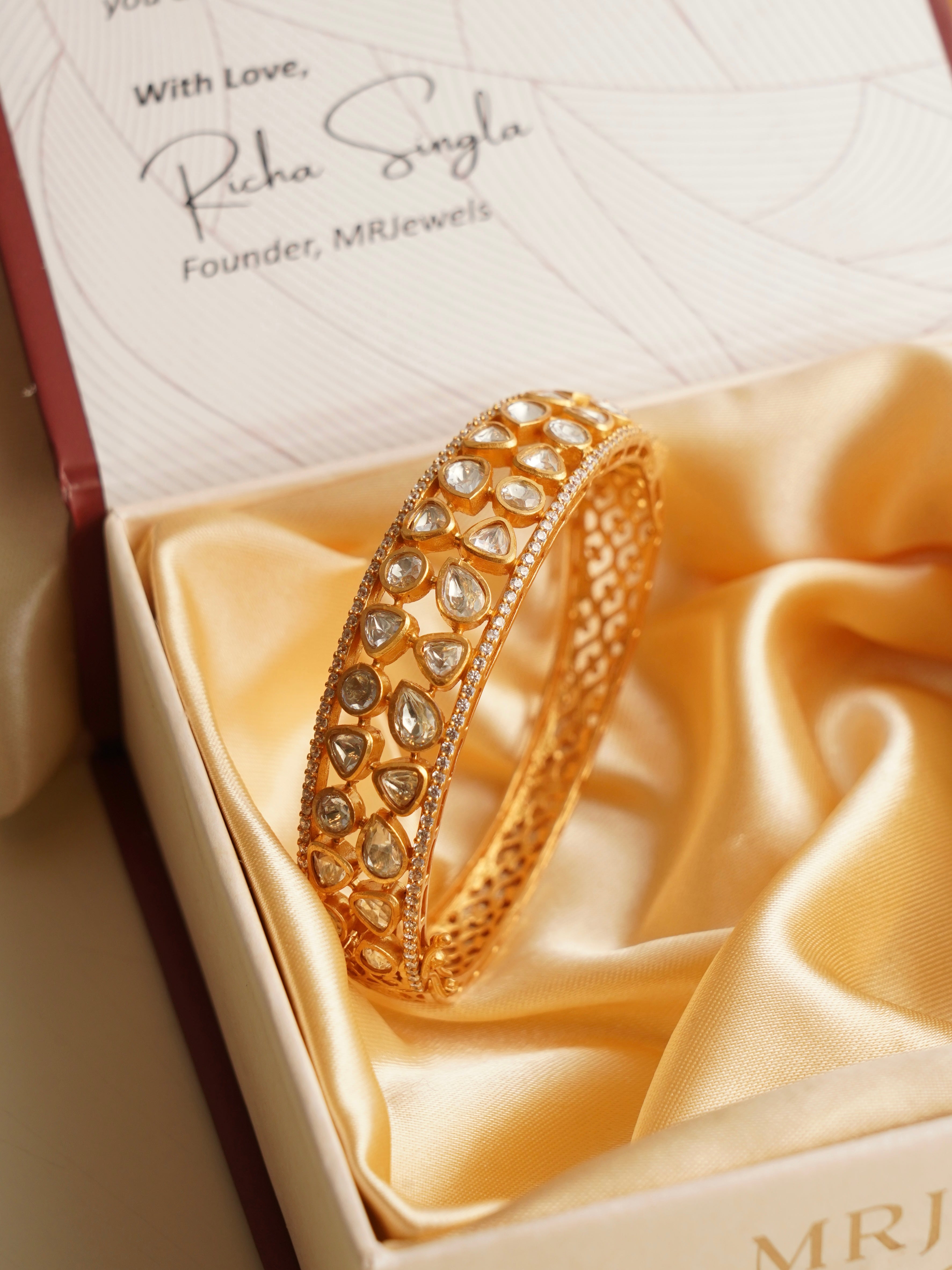 Top view of elegant kada with radiant moissanite stones and ornate detailing