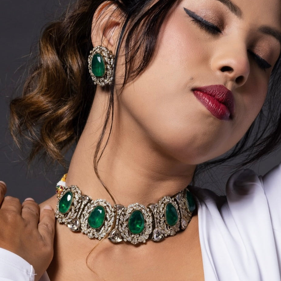 Side view of emerald choker and matching stud earrings with elegant detailing