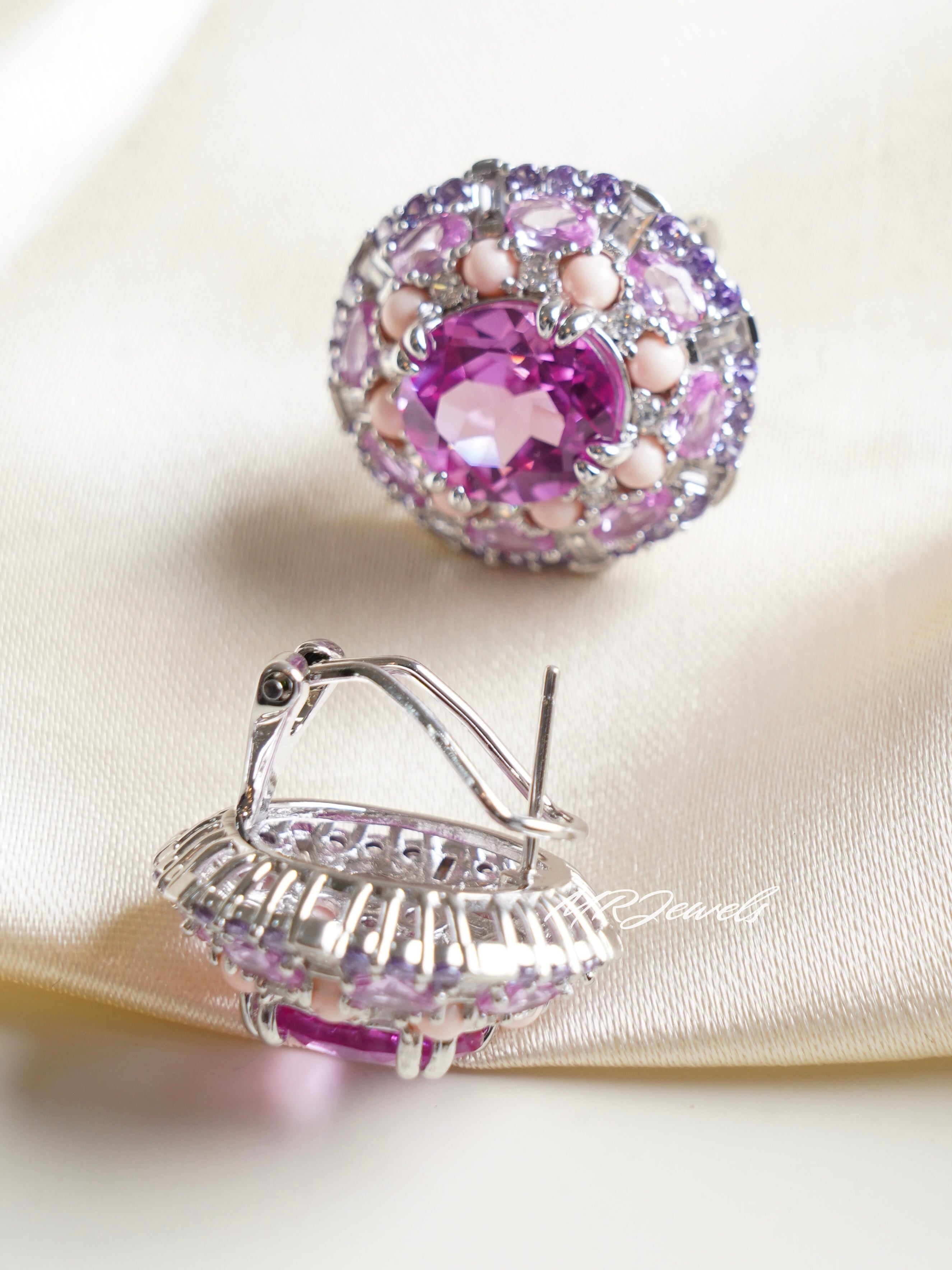 Side view of platinum-plated swarovski studs showing brilliant faceted sparkle and curved base