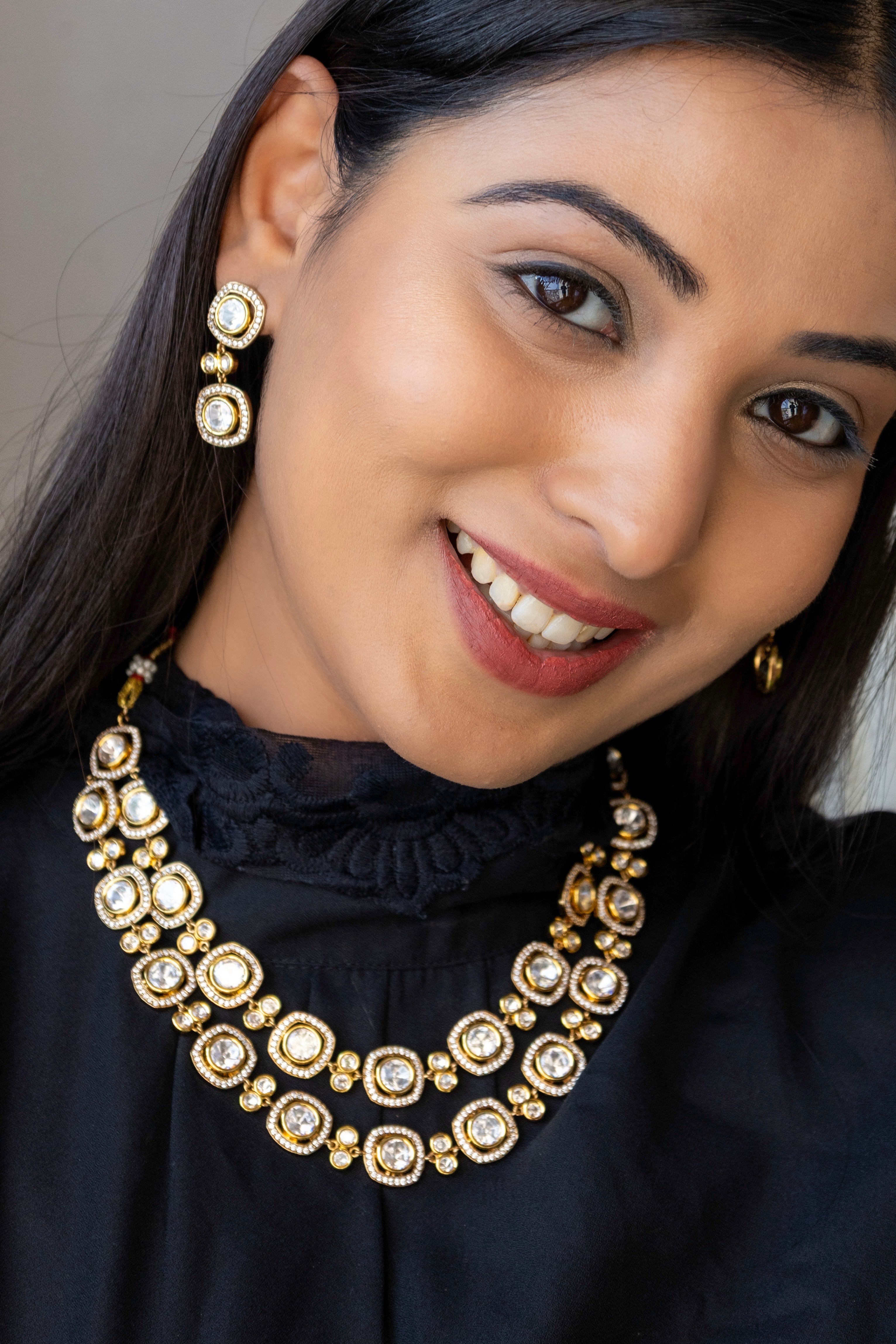 Double-layered kundan necklace with maangtikka and earrings, rich in intricate detail