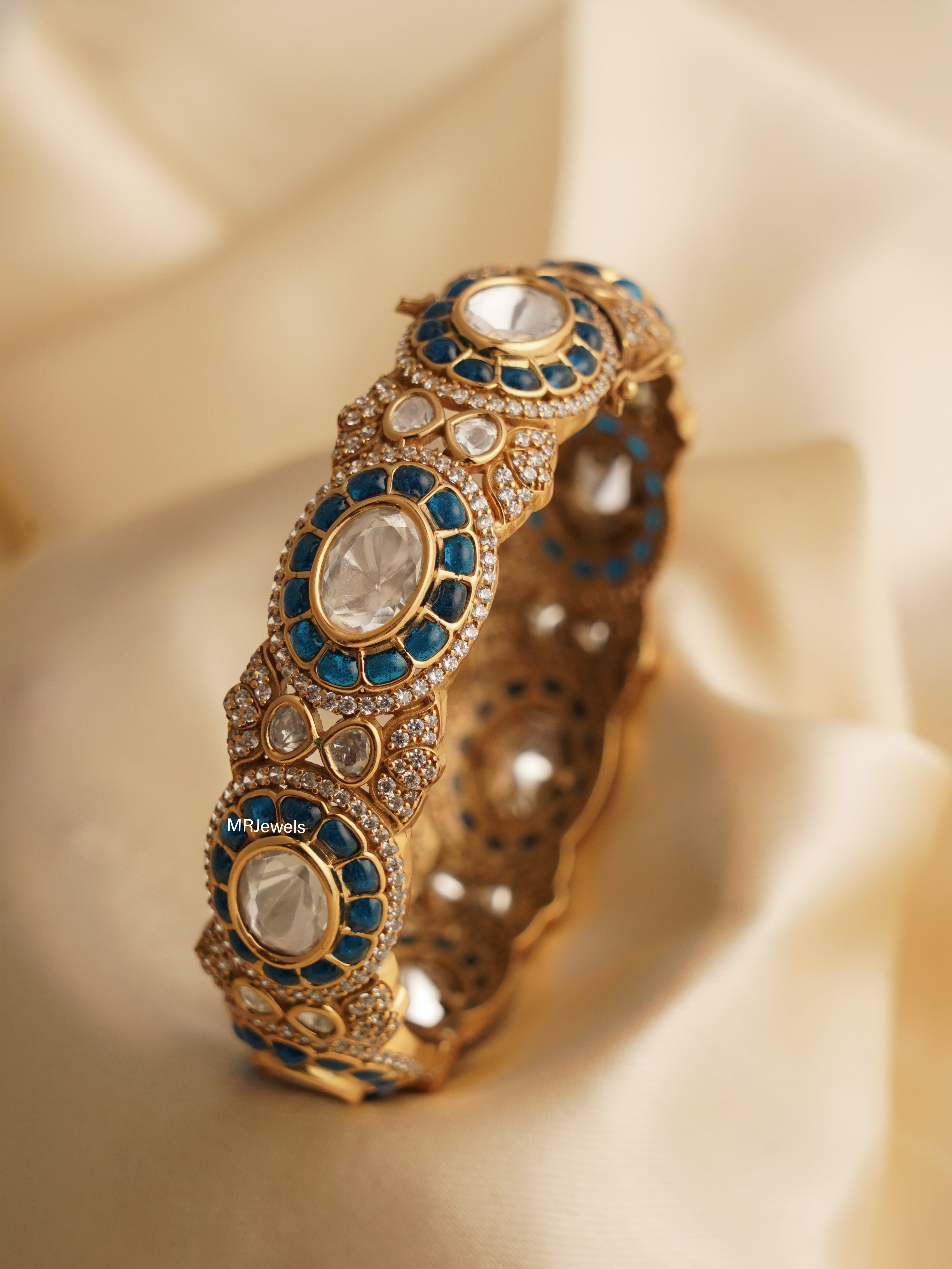 Front view of ruby bangle featuring vibrant stones in classic gold-toned setting