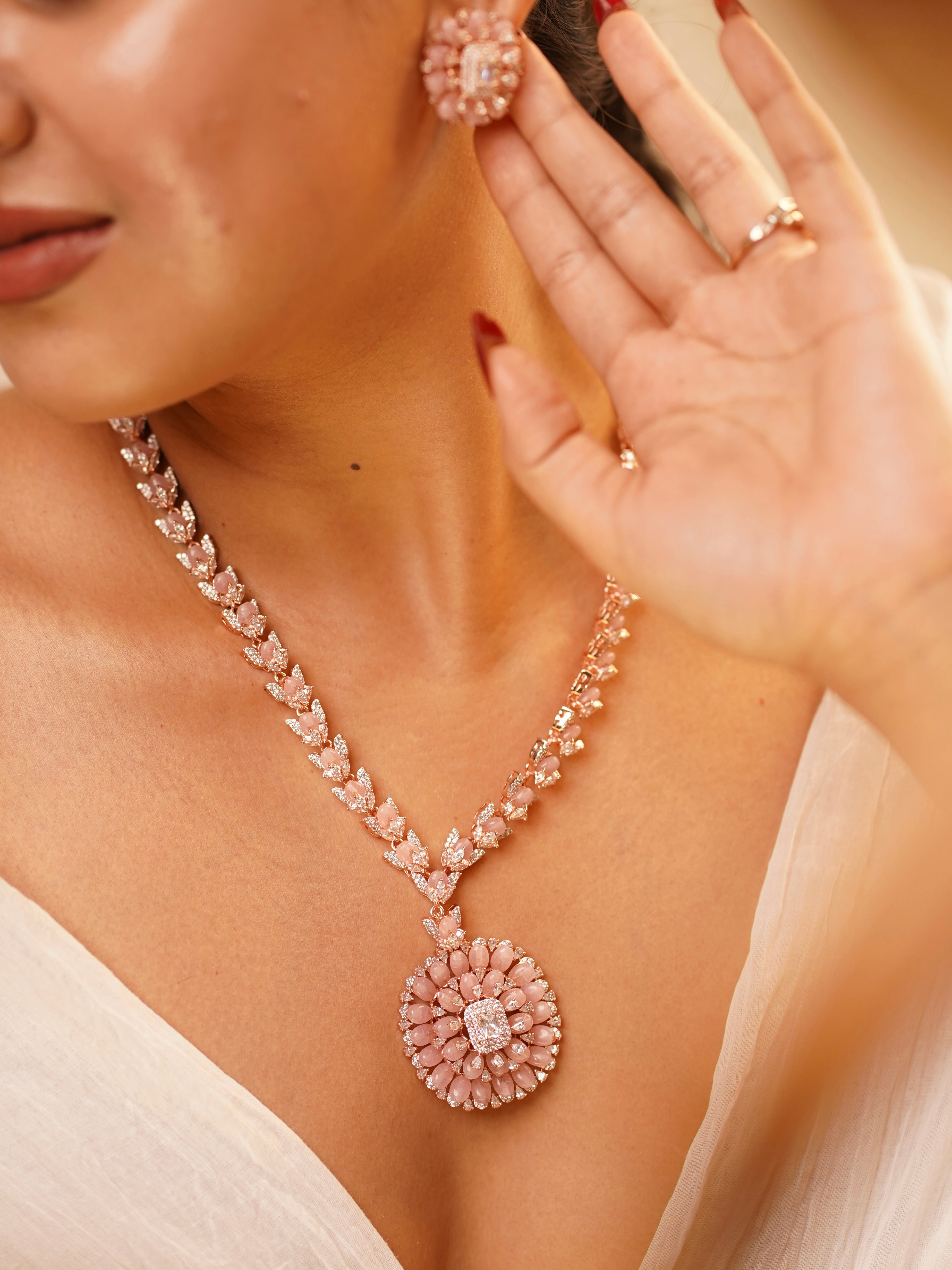 close-up of beaded long necklace in rose finish with circular matching studs