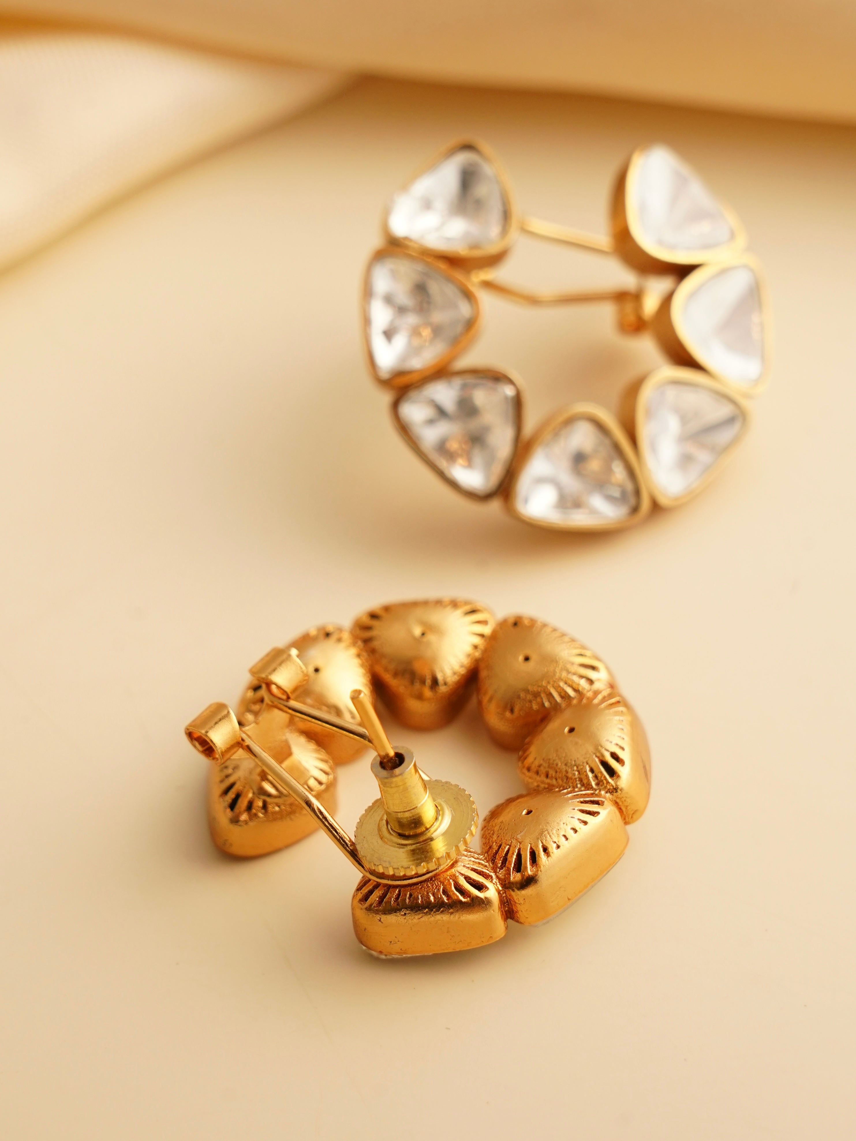 Angled view of uncut polki stone earrings with timeless charm