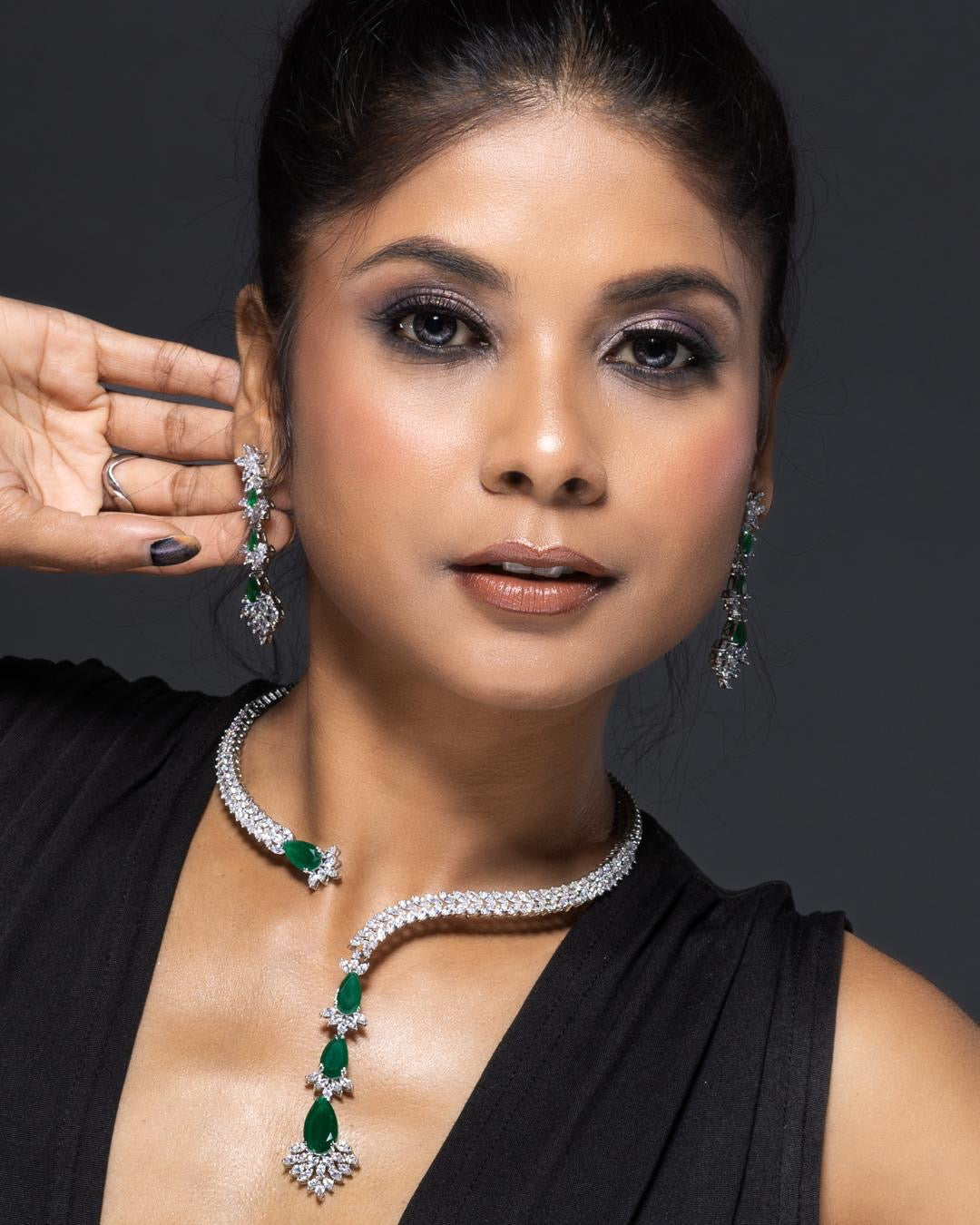 Designer emerald necklace with asymmetrical layout and refined stone setting