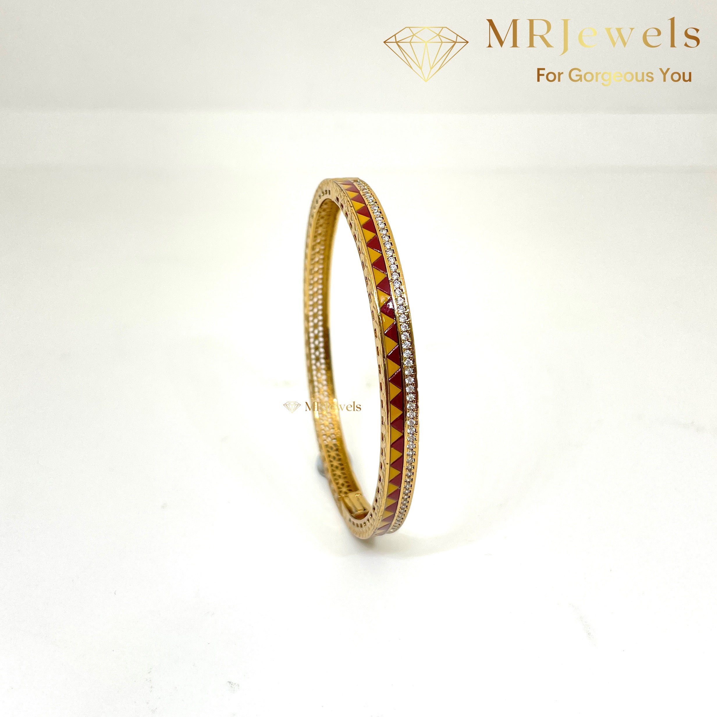 Top view of enamel bracelet highlighting clasp and sleek gold-plated surface