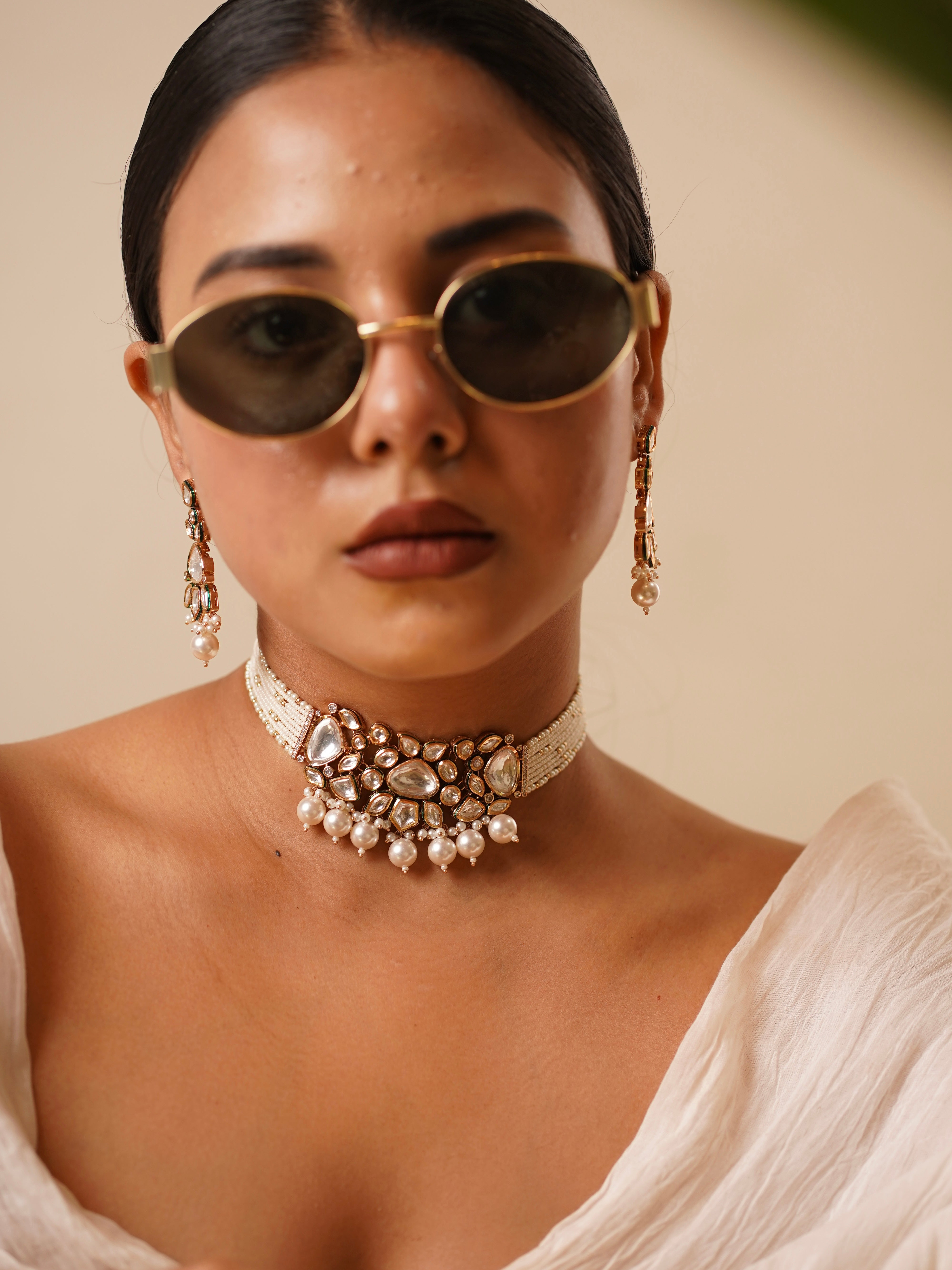 Close-up of Nooré choker necklace with polki-style stones, layered pearls, and statement earrings