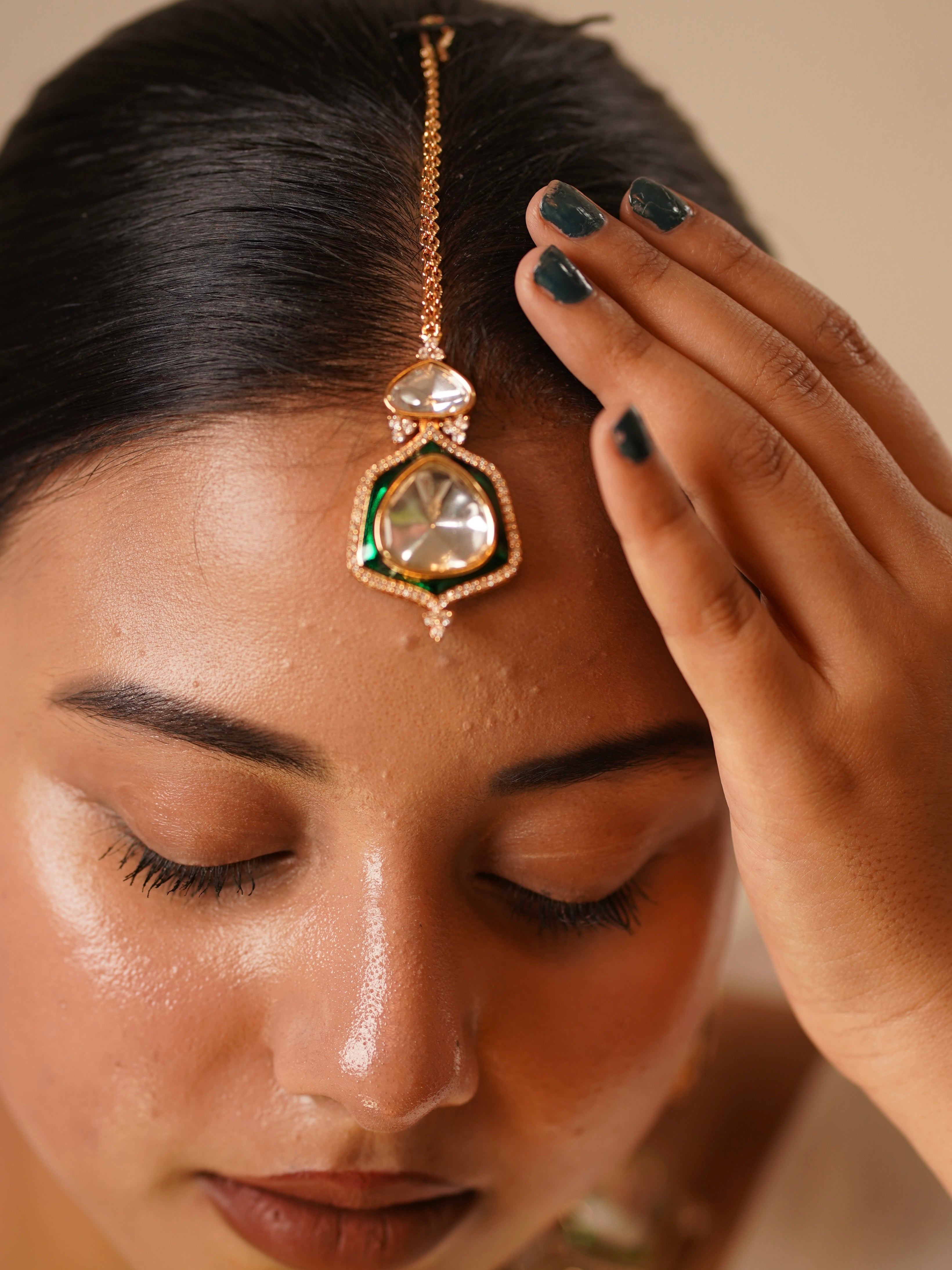 Angled view of kundan necklace set with maangtikka and traditional green enamel finish