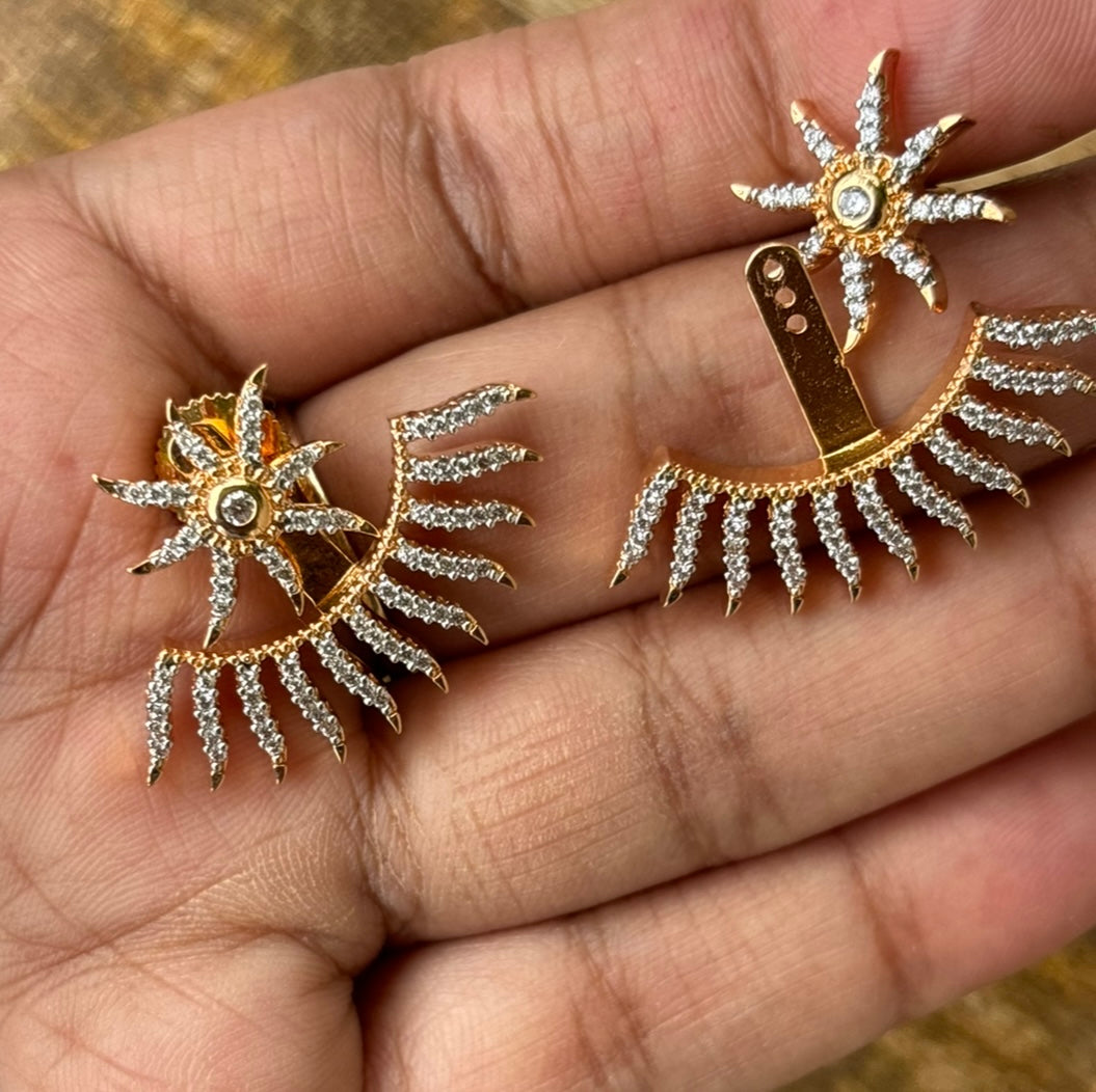 Starburst earrings with wraparound design and shimmering celestial stone accents