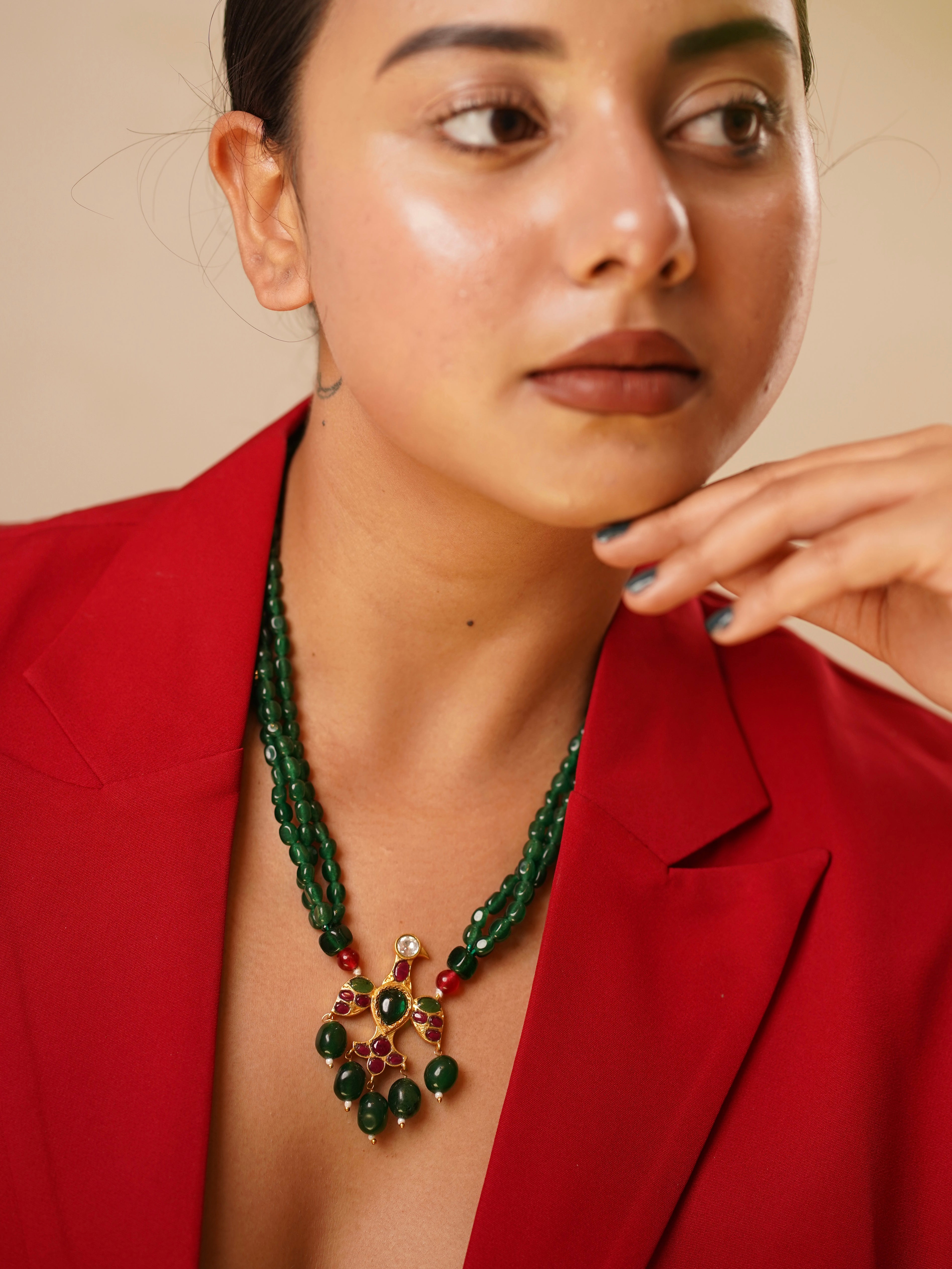 Emerald triple-strand bead necklace with eagle pendant and kundan detailing