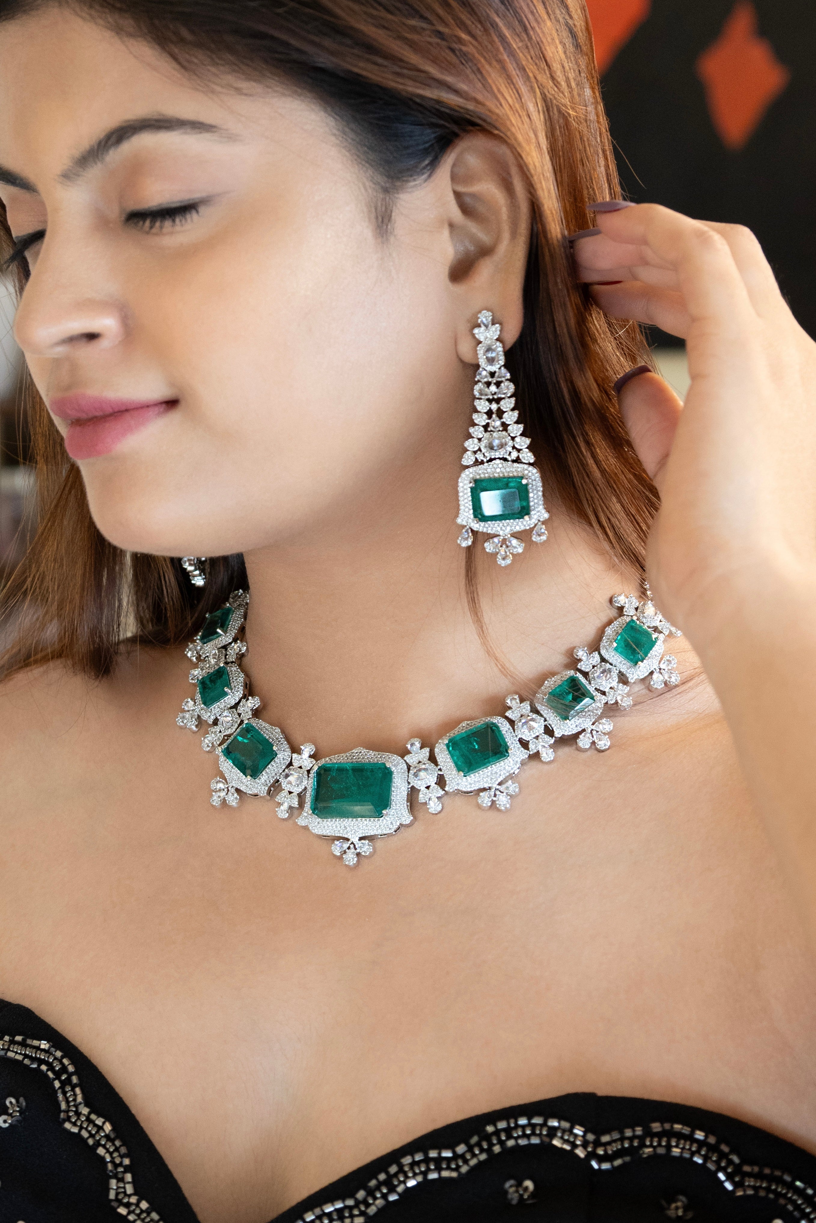 Emerald-cut diamond necklace with clustered setting and matching drop earrings