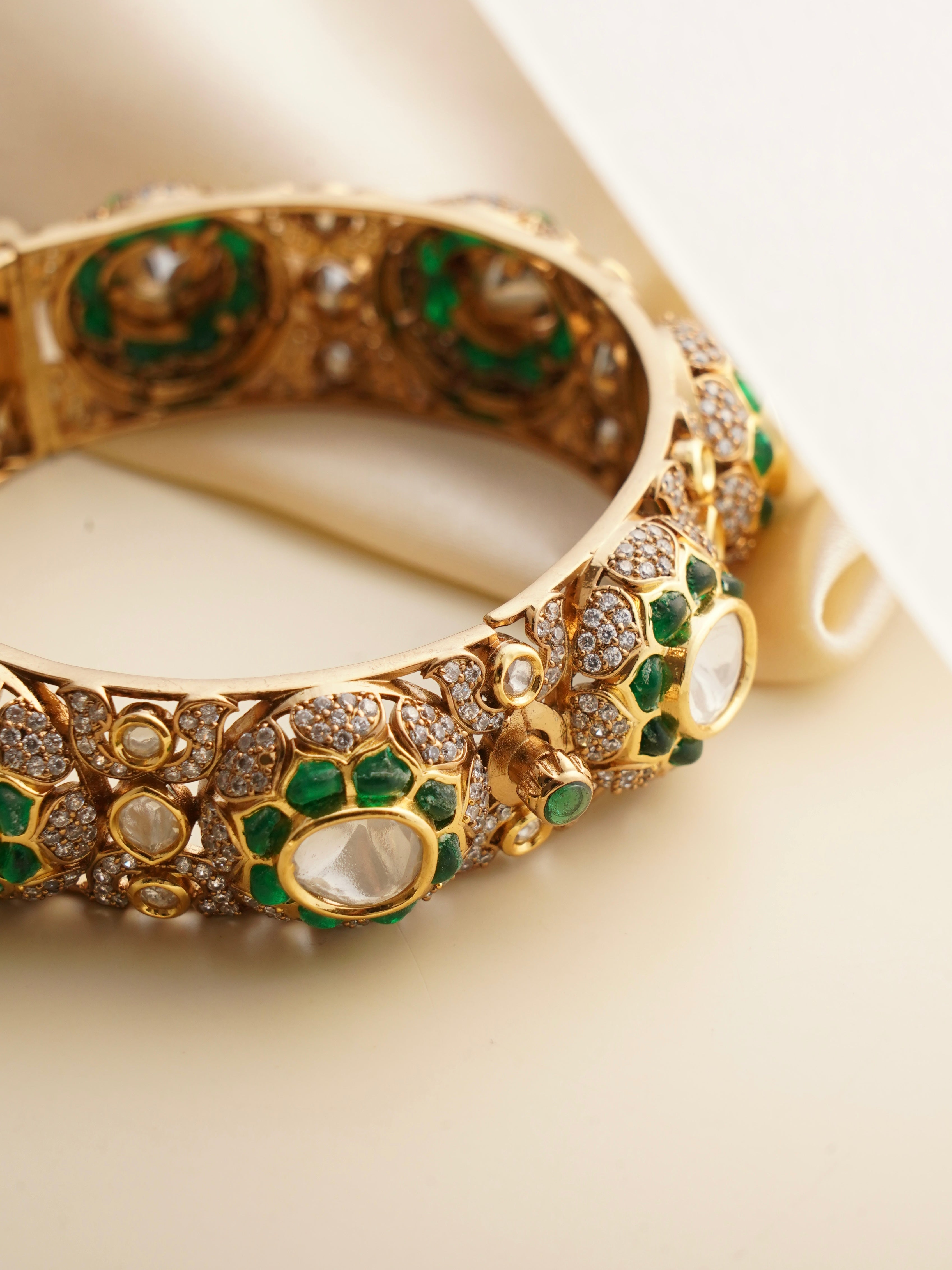 Top view of bridal kada with CZ diamonds and red-green enamel work