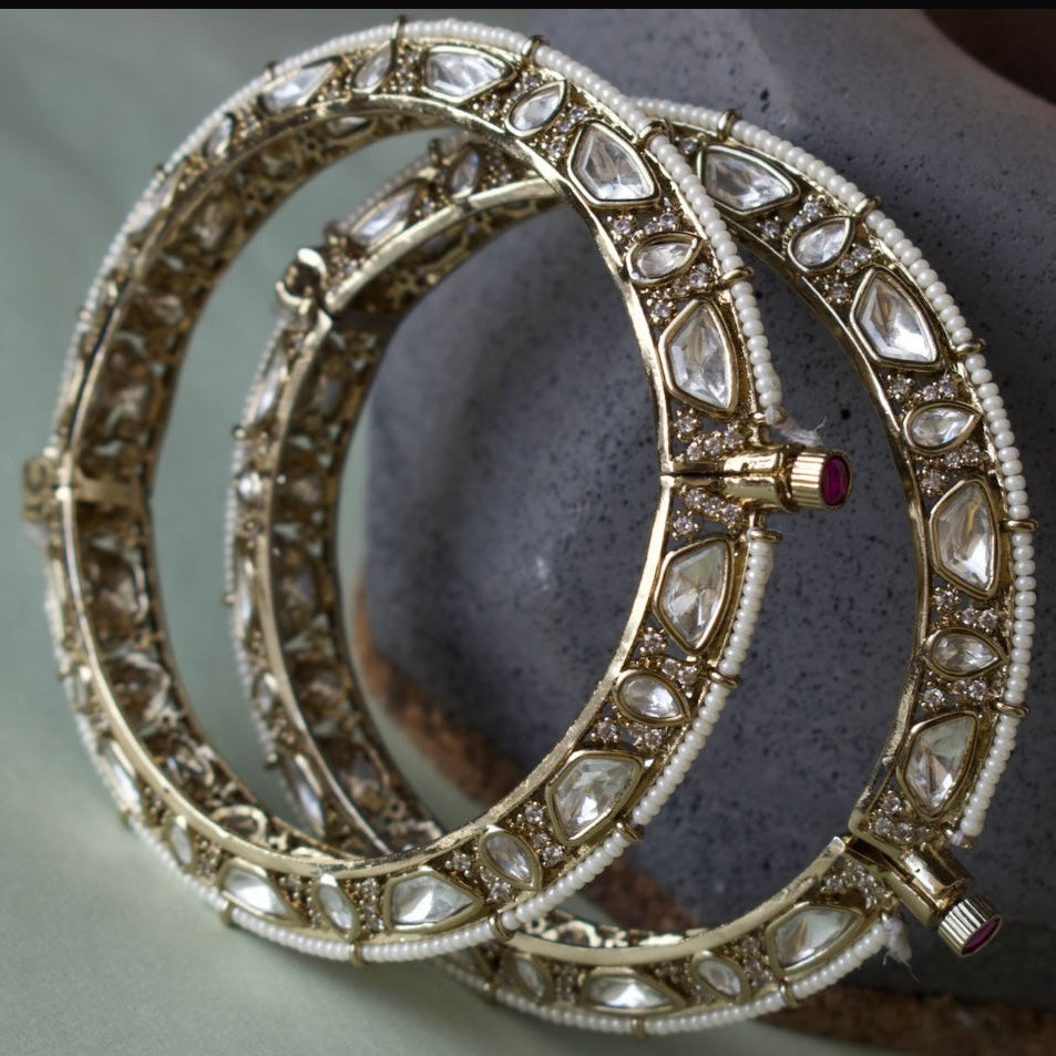Polki bangles with pearl accents and ornate detailing in front view