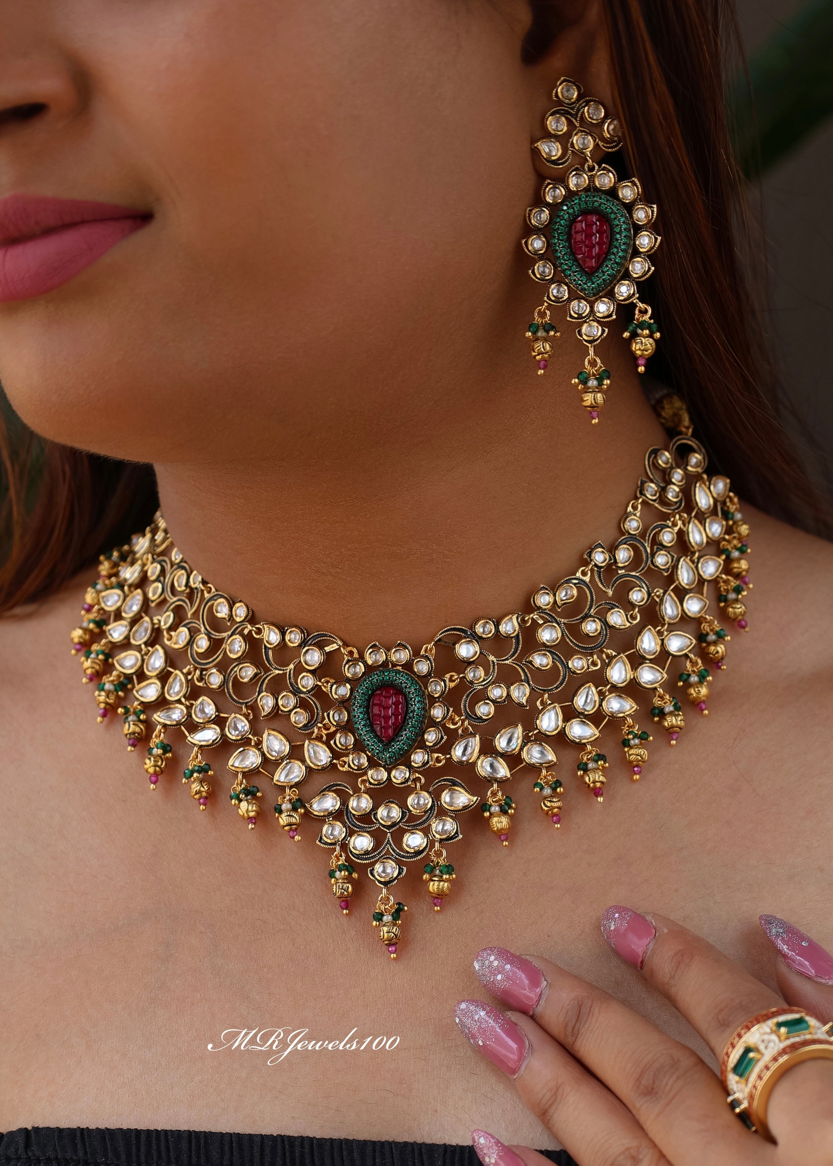polki and ruby necklace set with intricate detailing and matching earrings