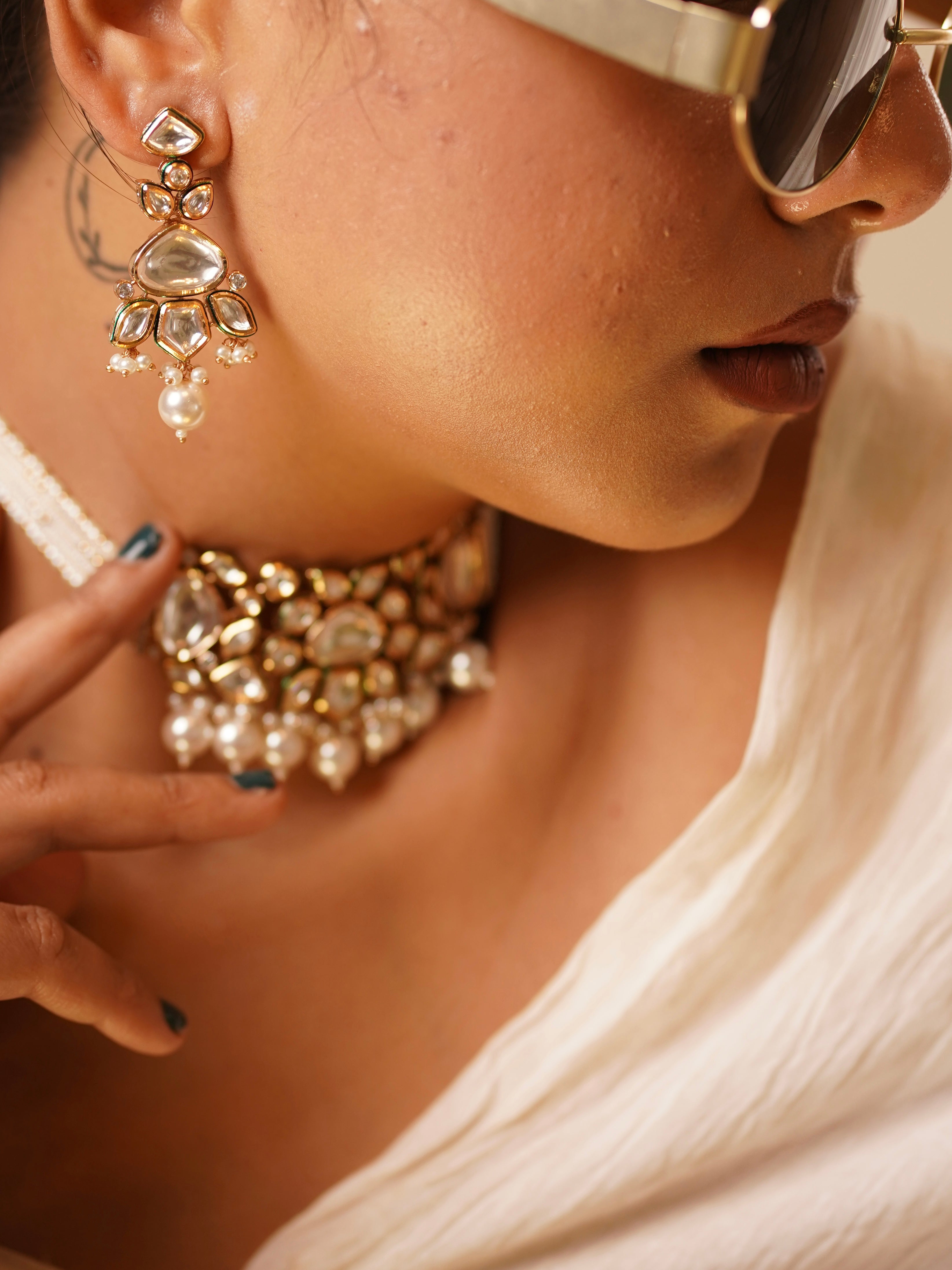 Gold-tone kundan pearl choker necklace with dangling pearl drops and floral detailing