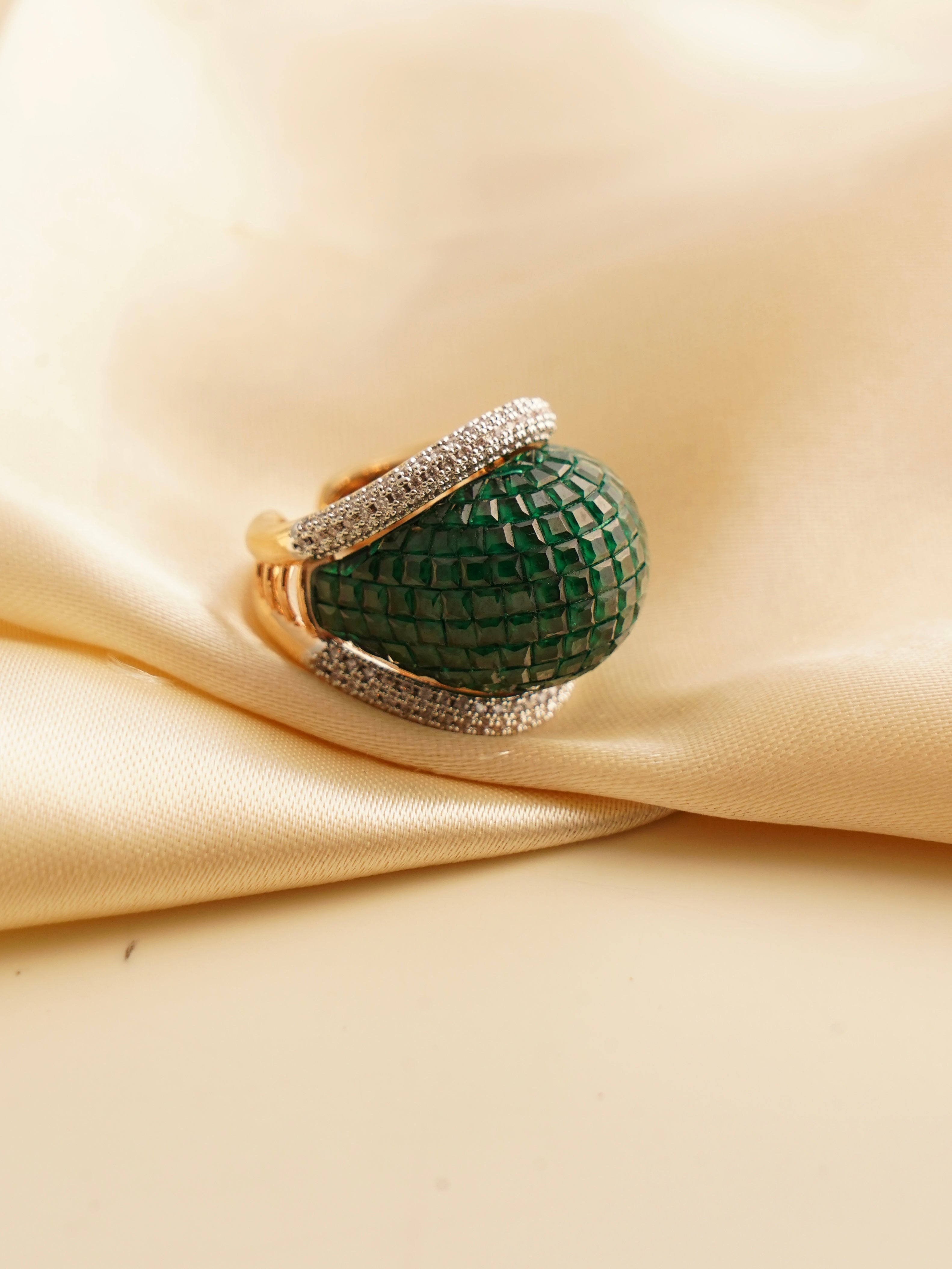 Top view of emerald statement ring showcasing sculpted design with emerald mosaic and CZ highlights