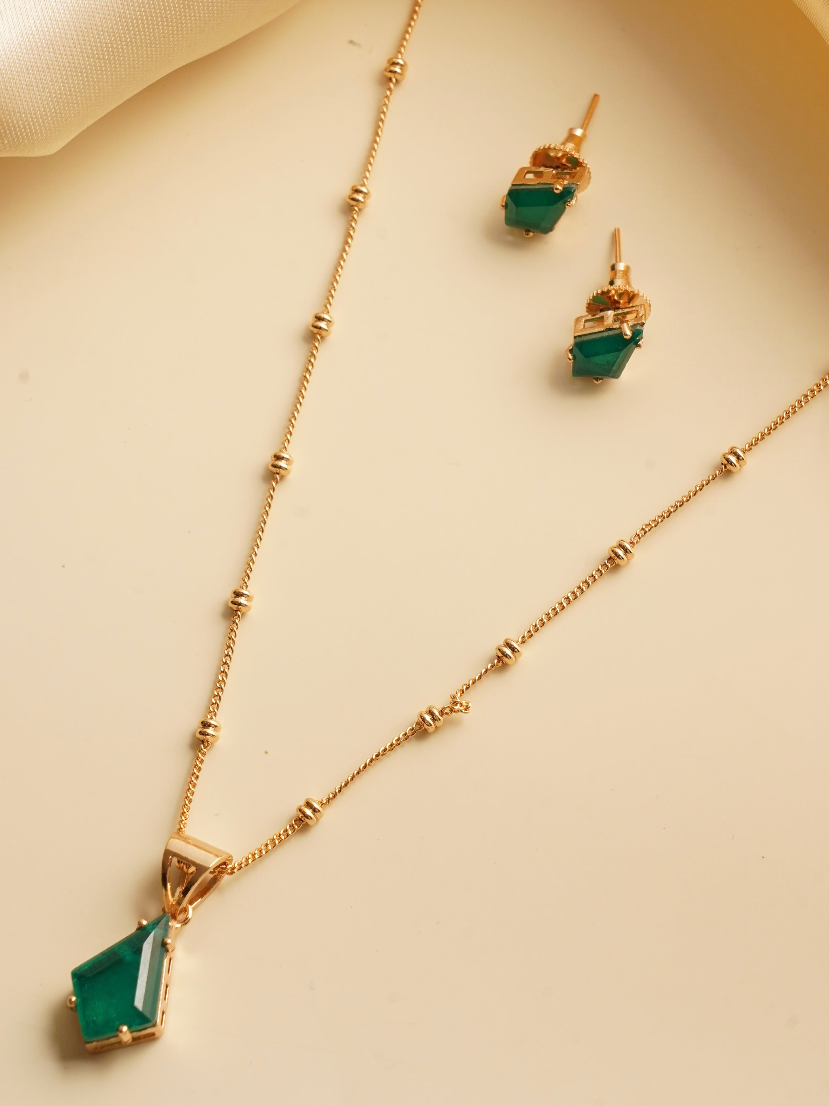 Ruby prism pendant with matching stud earrings in gold-toned beaded chain setting