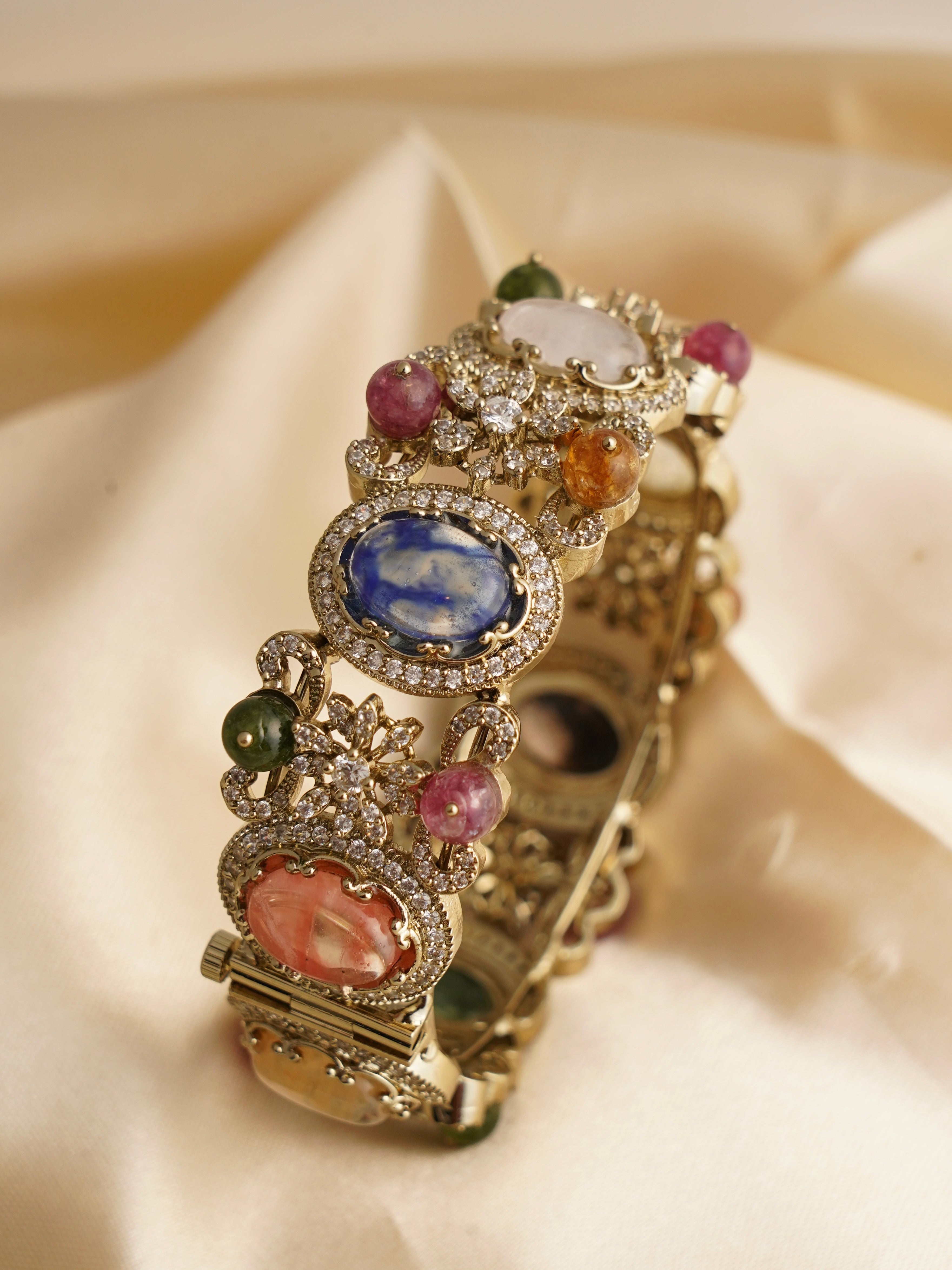 Antique gold kada bracelet with multicolour gemstones, floral motifs, and zirconia accents