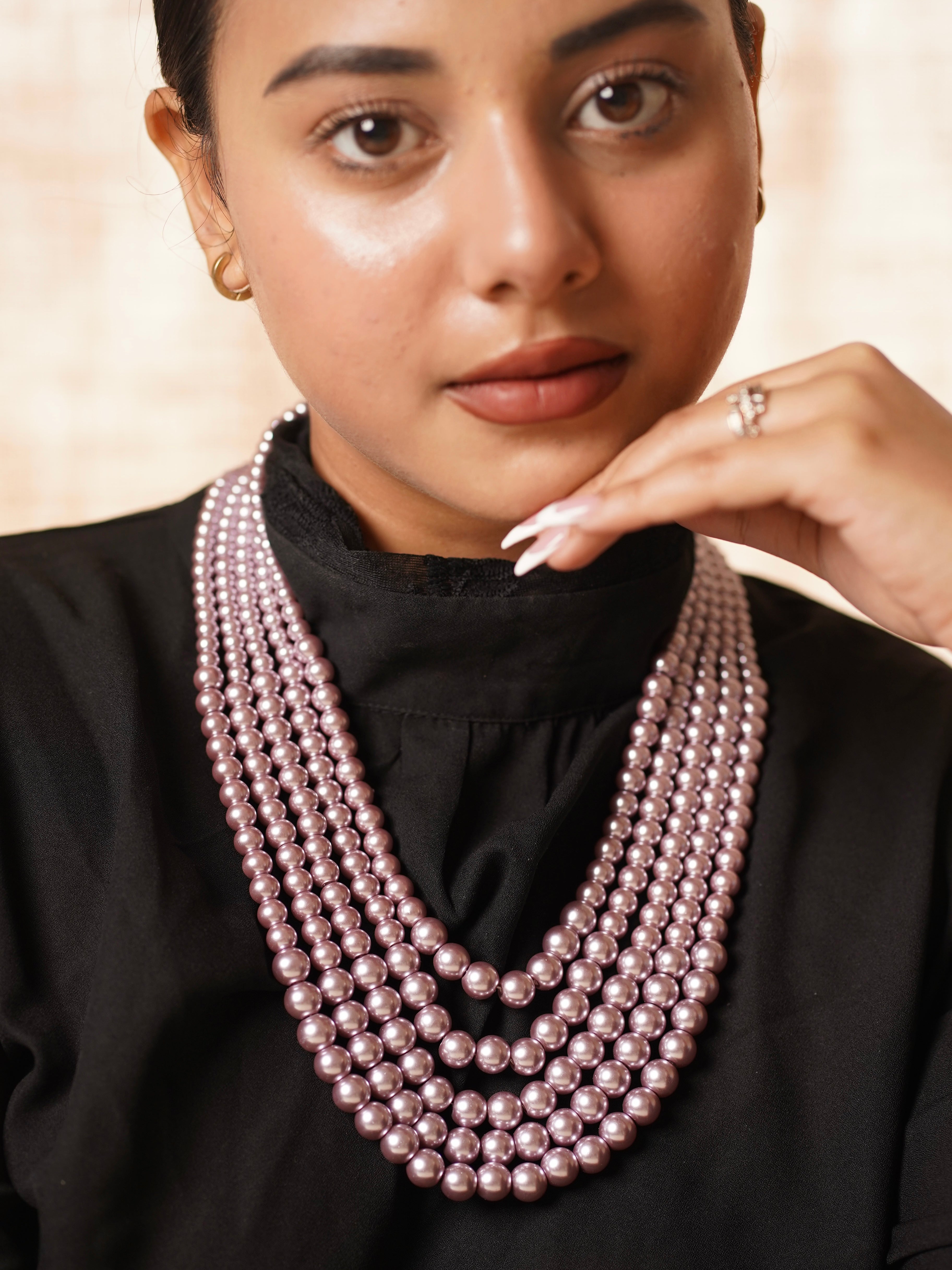 Five-layer pearl necklace with graduated strands and floral clasp detail