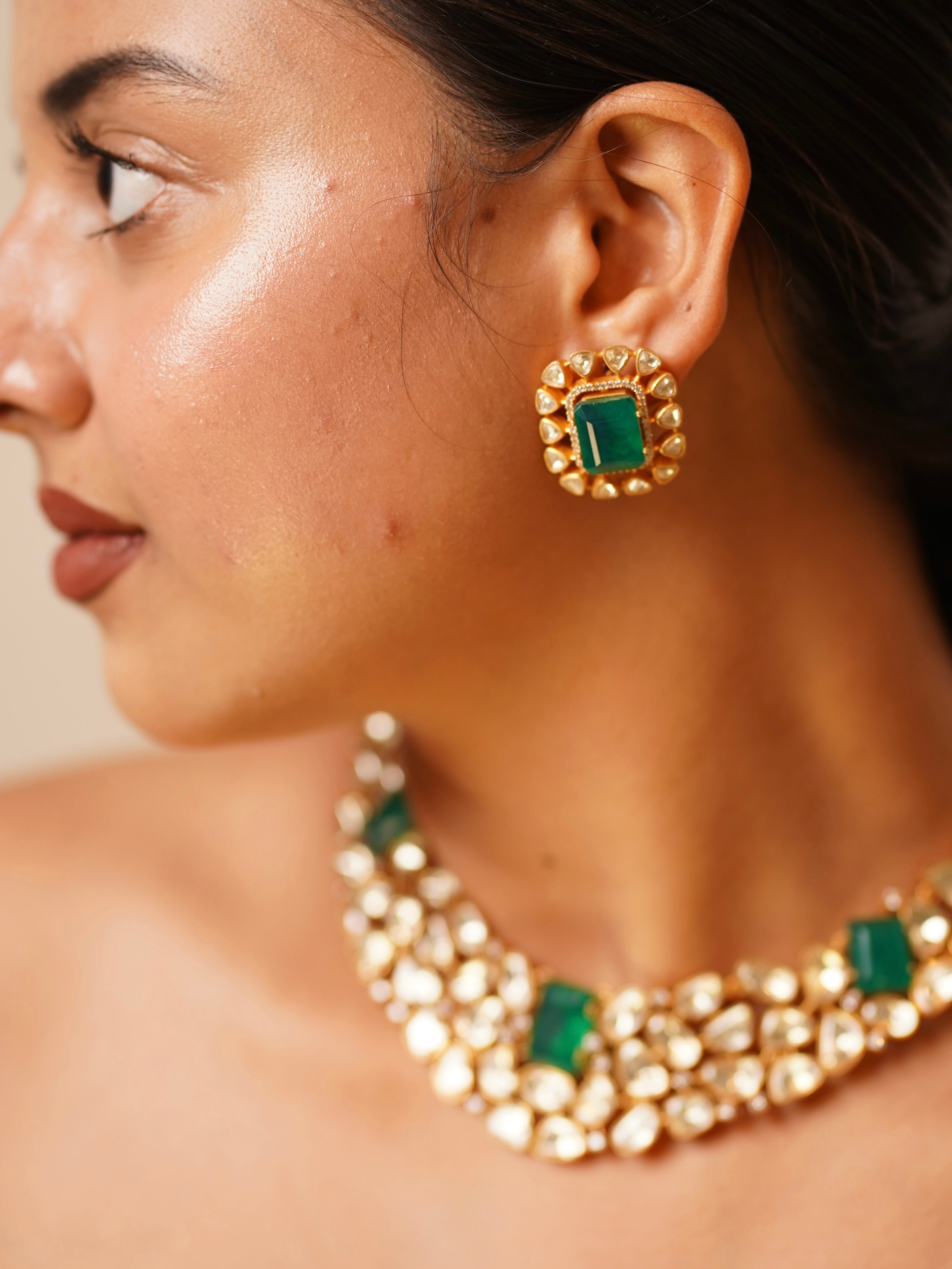 Close-up of gold-plated choker showing intricate kundan work and pearl details