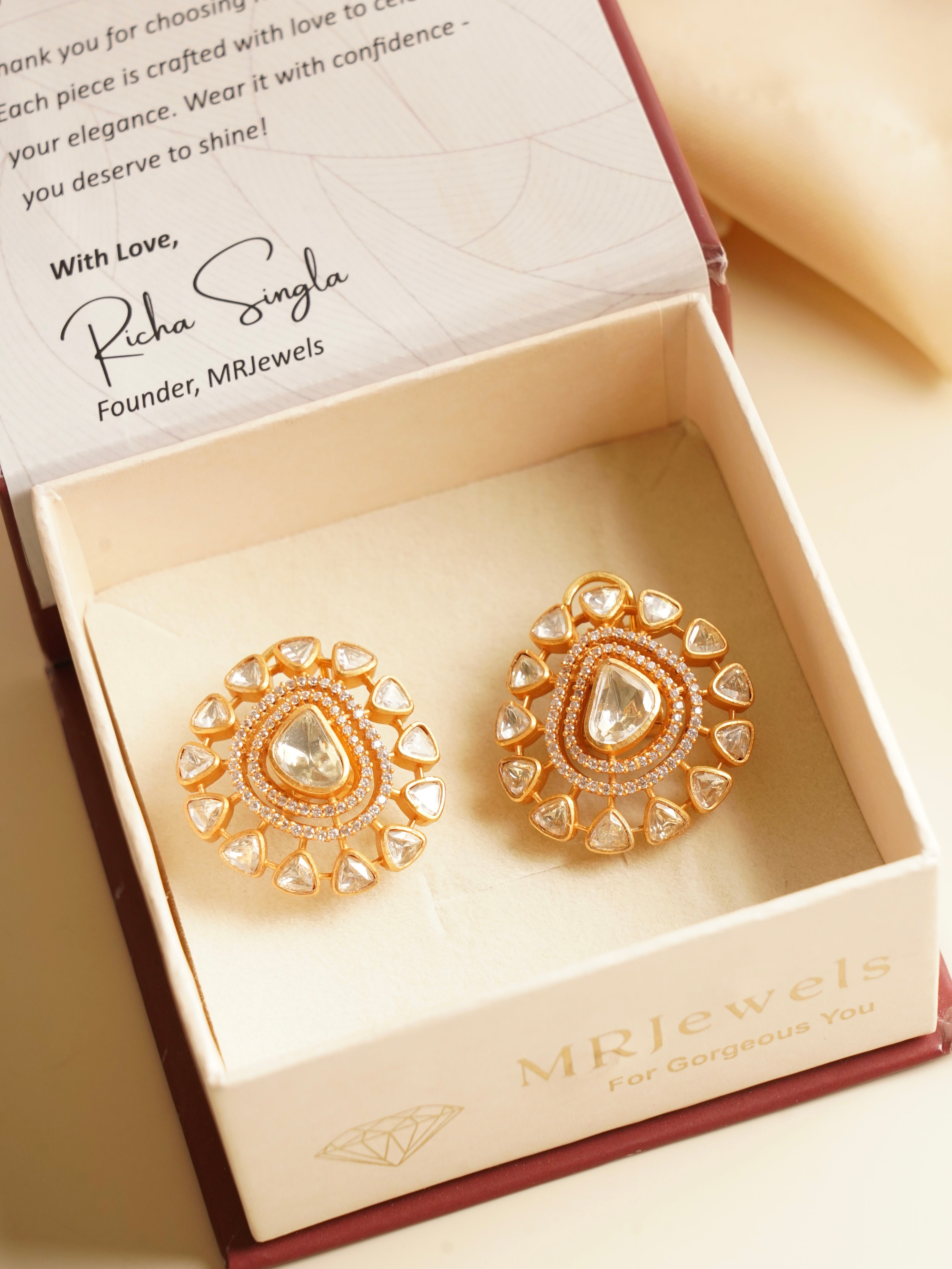 Close-up of gold polki studs with uncut moissanite stones and screwback fitting