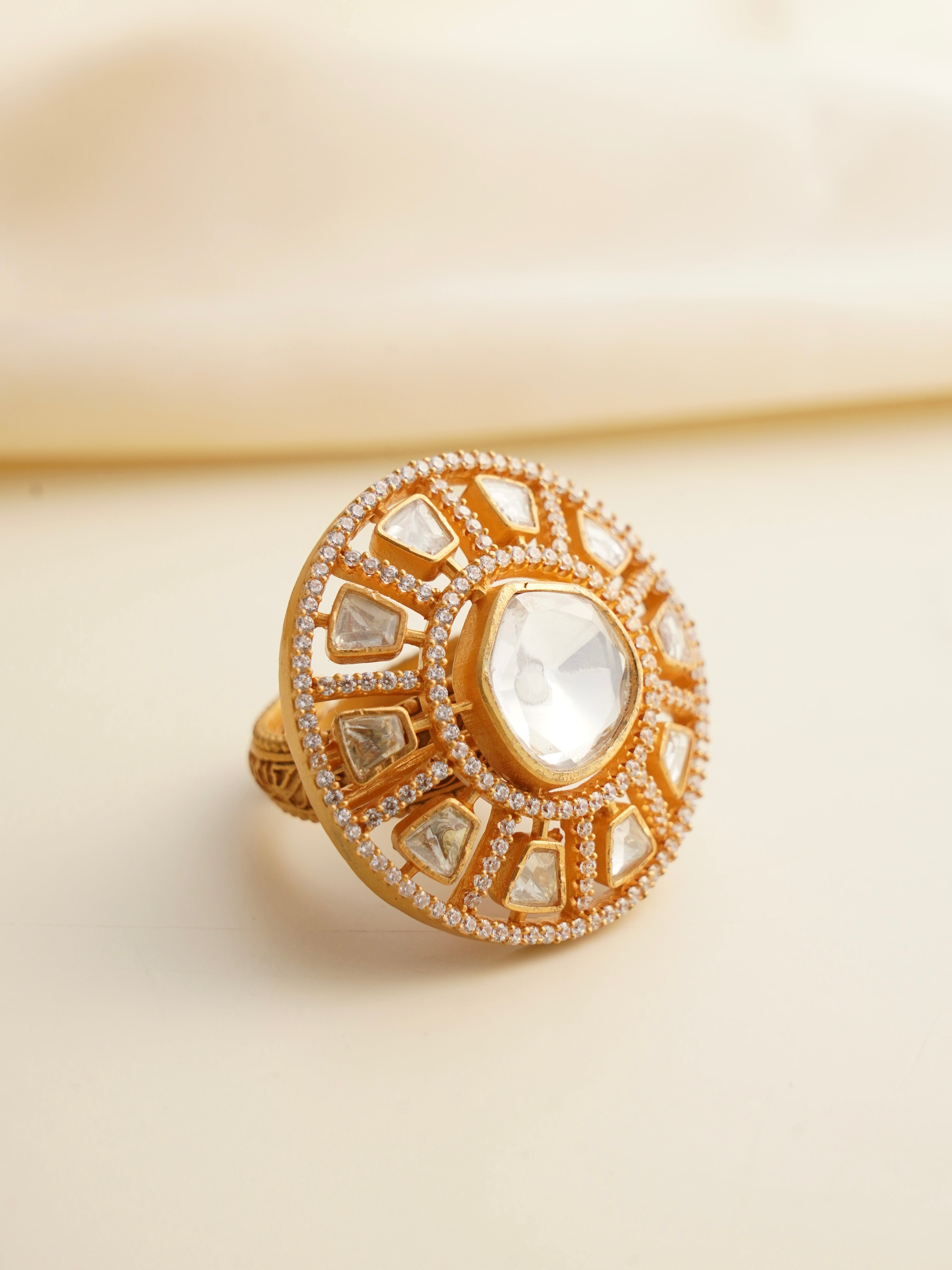 Moissanite statement ring with round centerpiece surrounded by polki-style stones and micro zircons