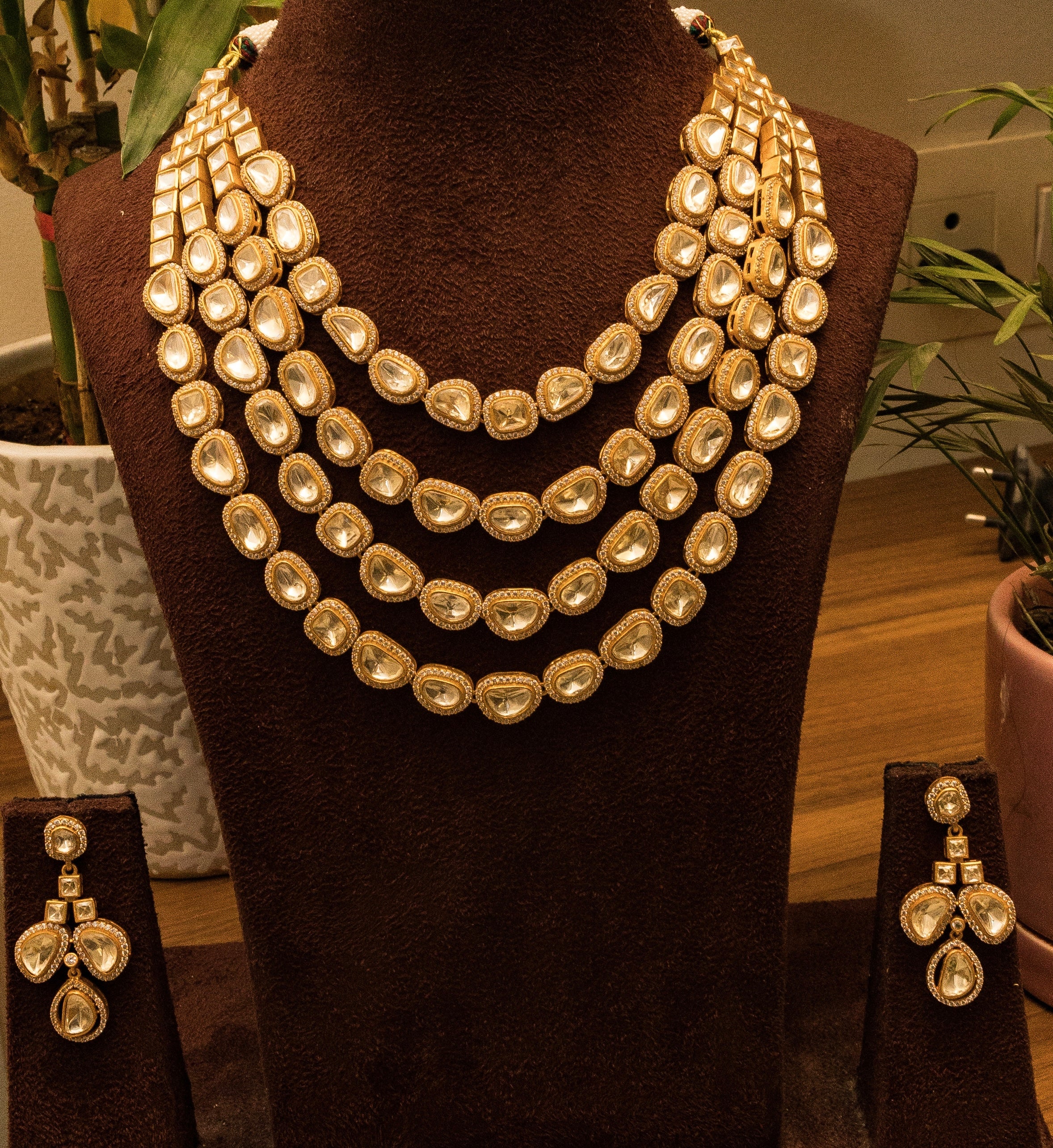 Full view of moissanite necklace and screwback earrings with luxurious gold plating