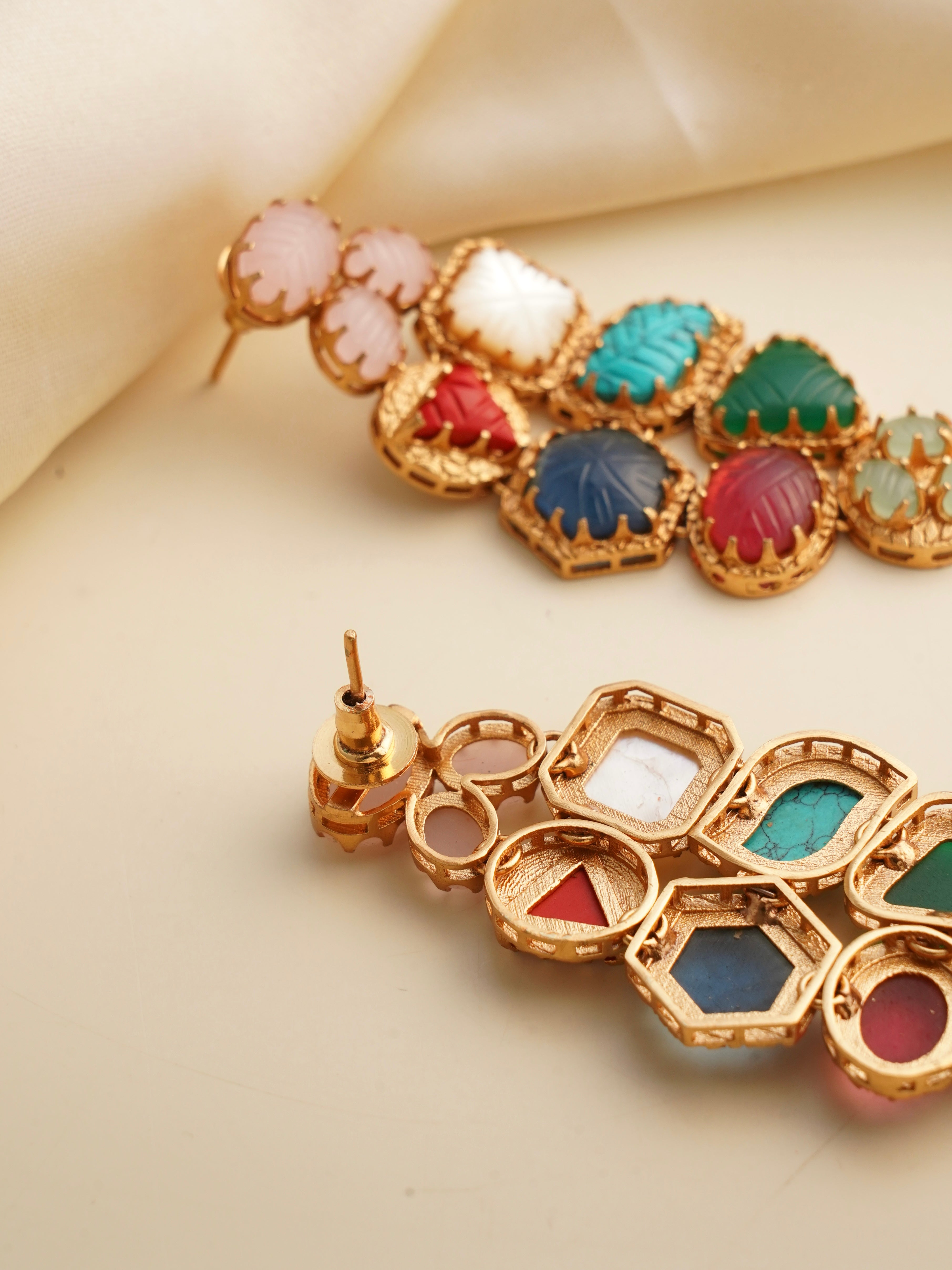 side view of colorful navrattan stone earrings with intricate cluster design