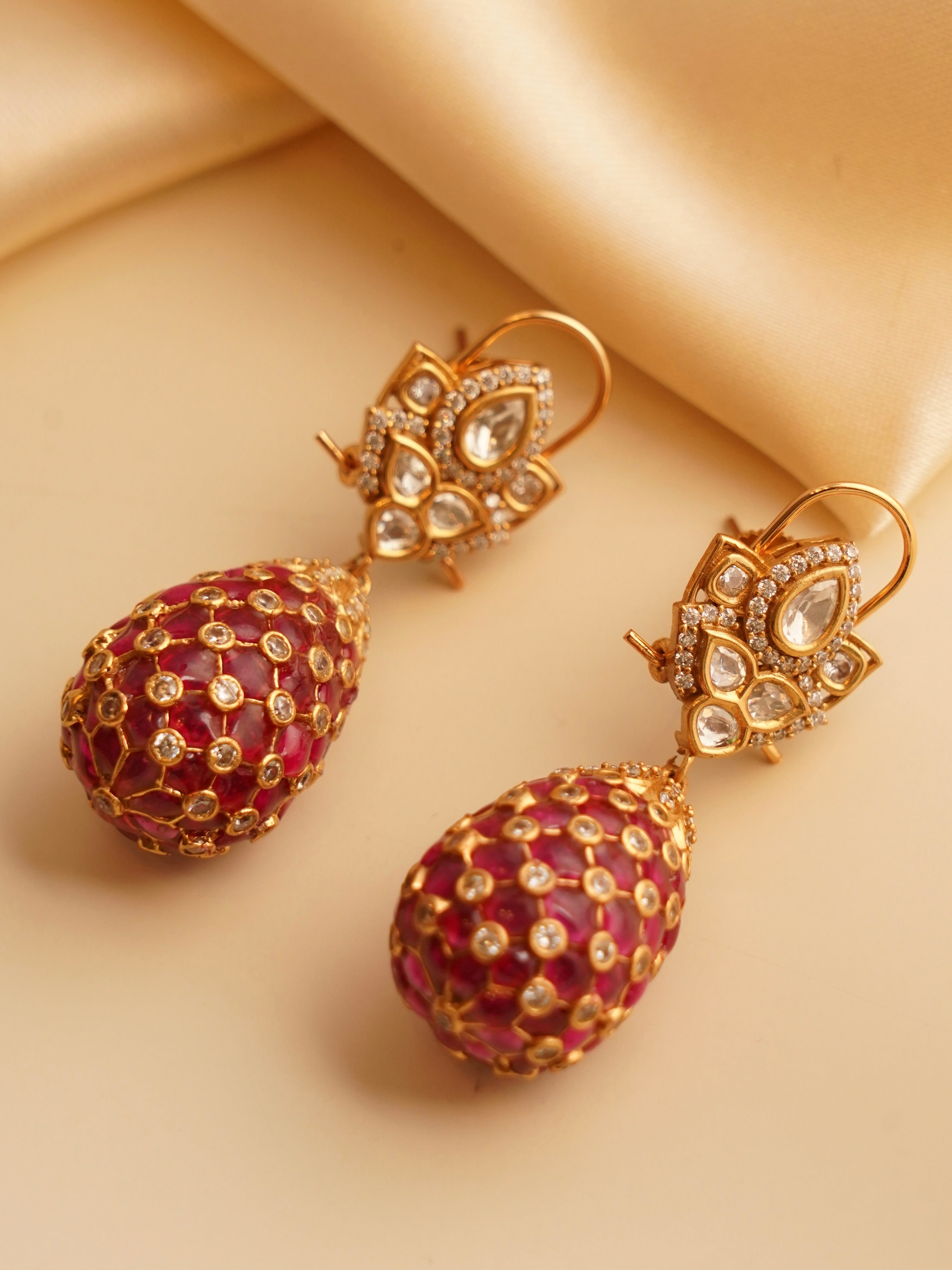front view of gold-finish polki droplet earrings with traditional Indian design