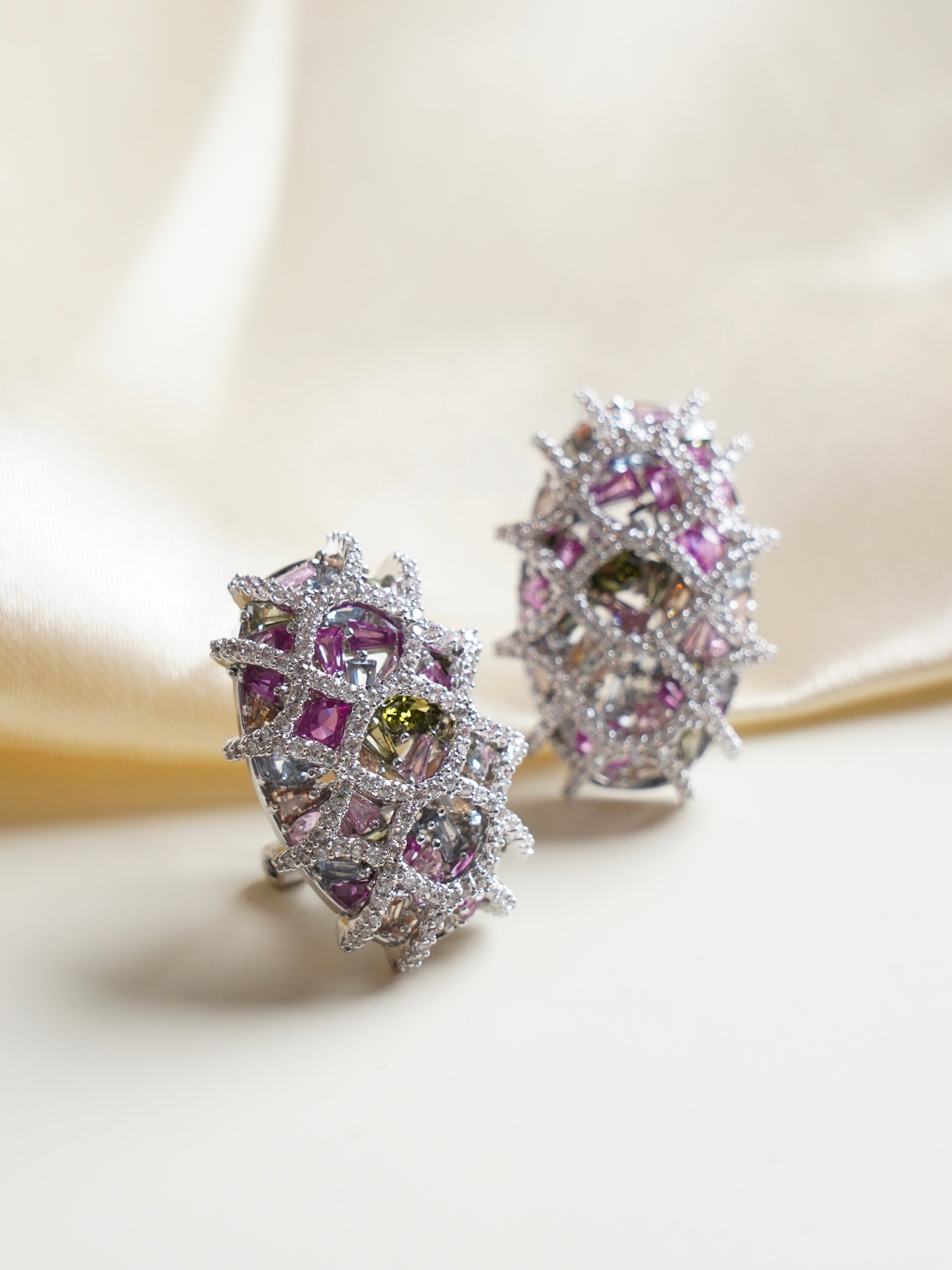 Swarovski stud earrings with oval lilac, green, and blush pink crystals in lattice-inspired setting