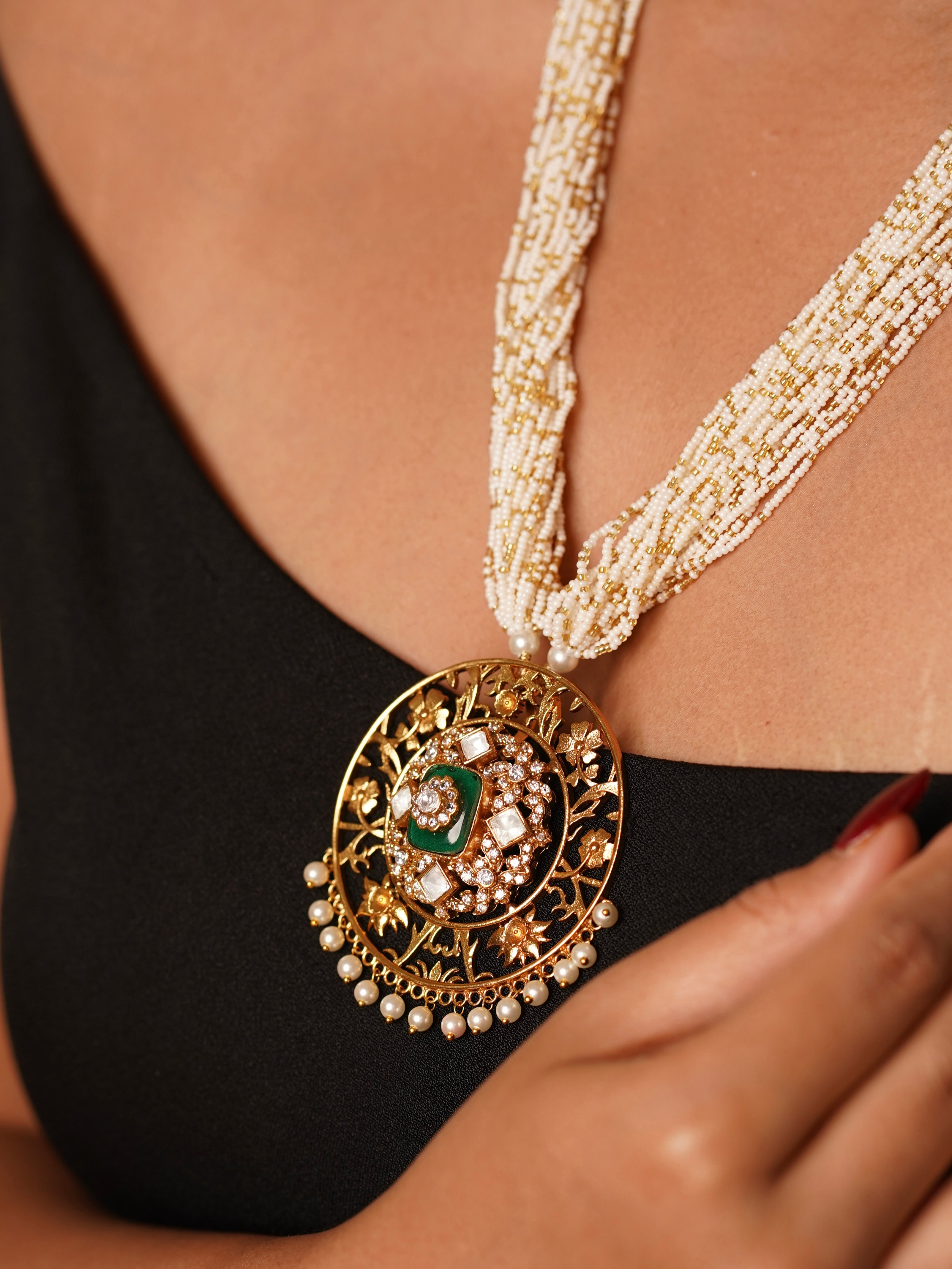 Close-up of matching studs from radhika set featuring kundan stones and fine gold plating