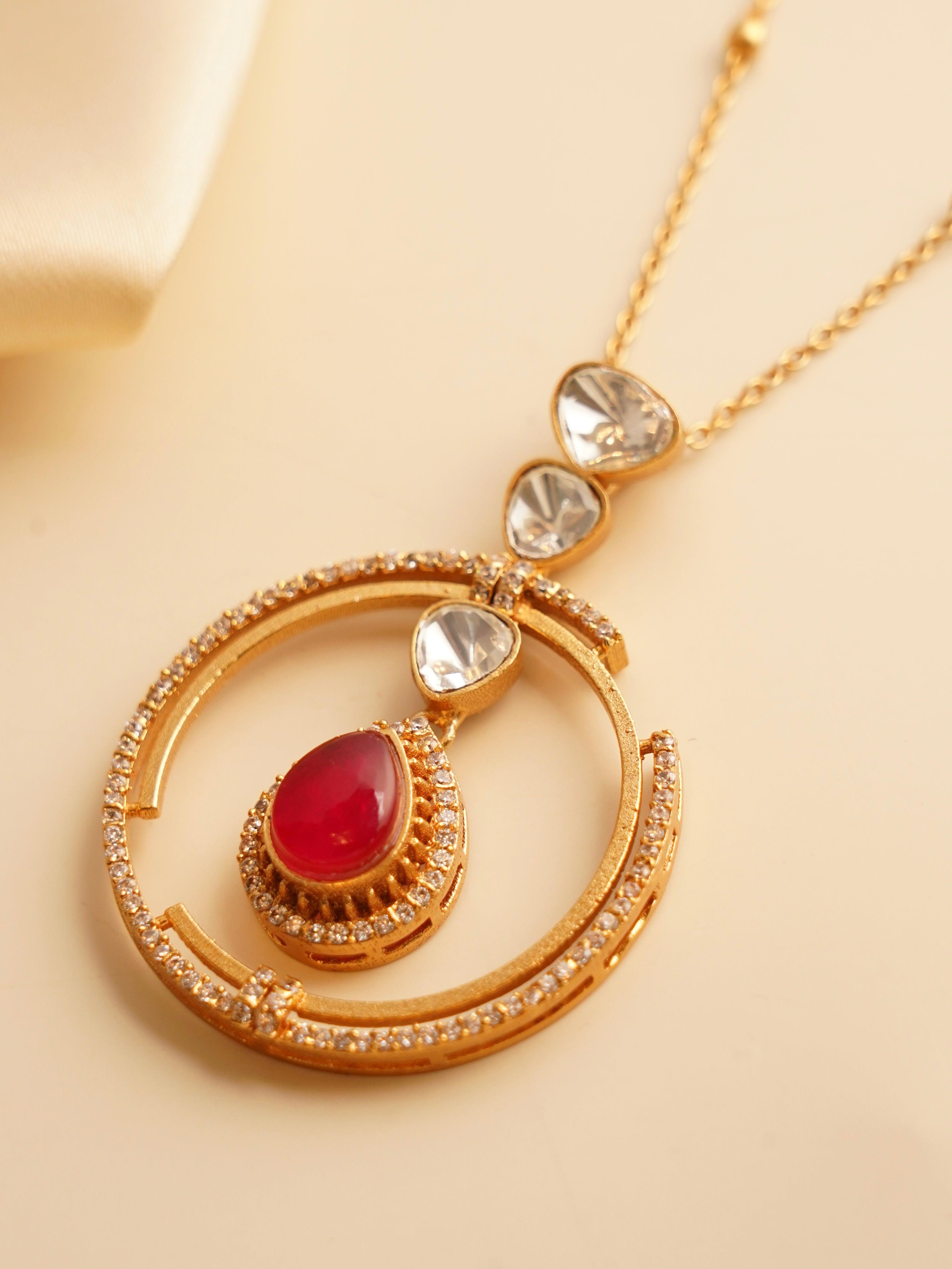 Close-up of ruby teardrop version of Ziva Circle Drop necklace with kundan-style setting
