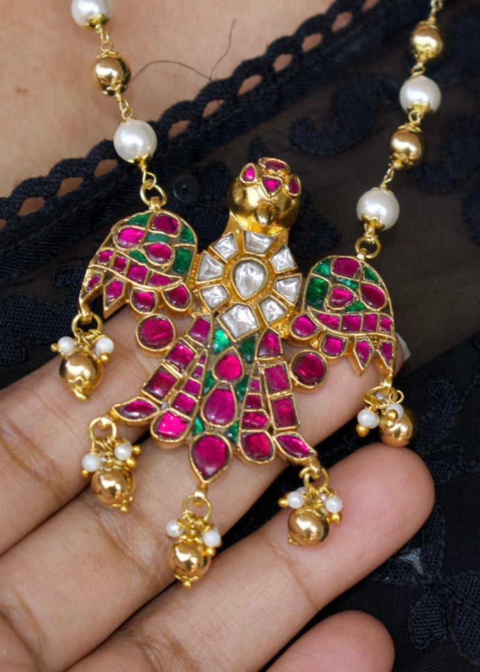 Eagle jadau pendant necklace with vibrant enamel, polki stones, and pearl chain detail