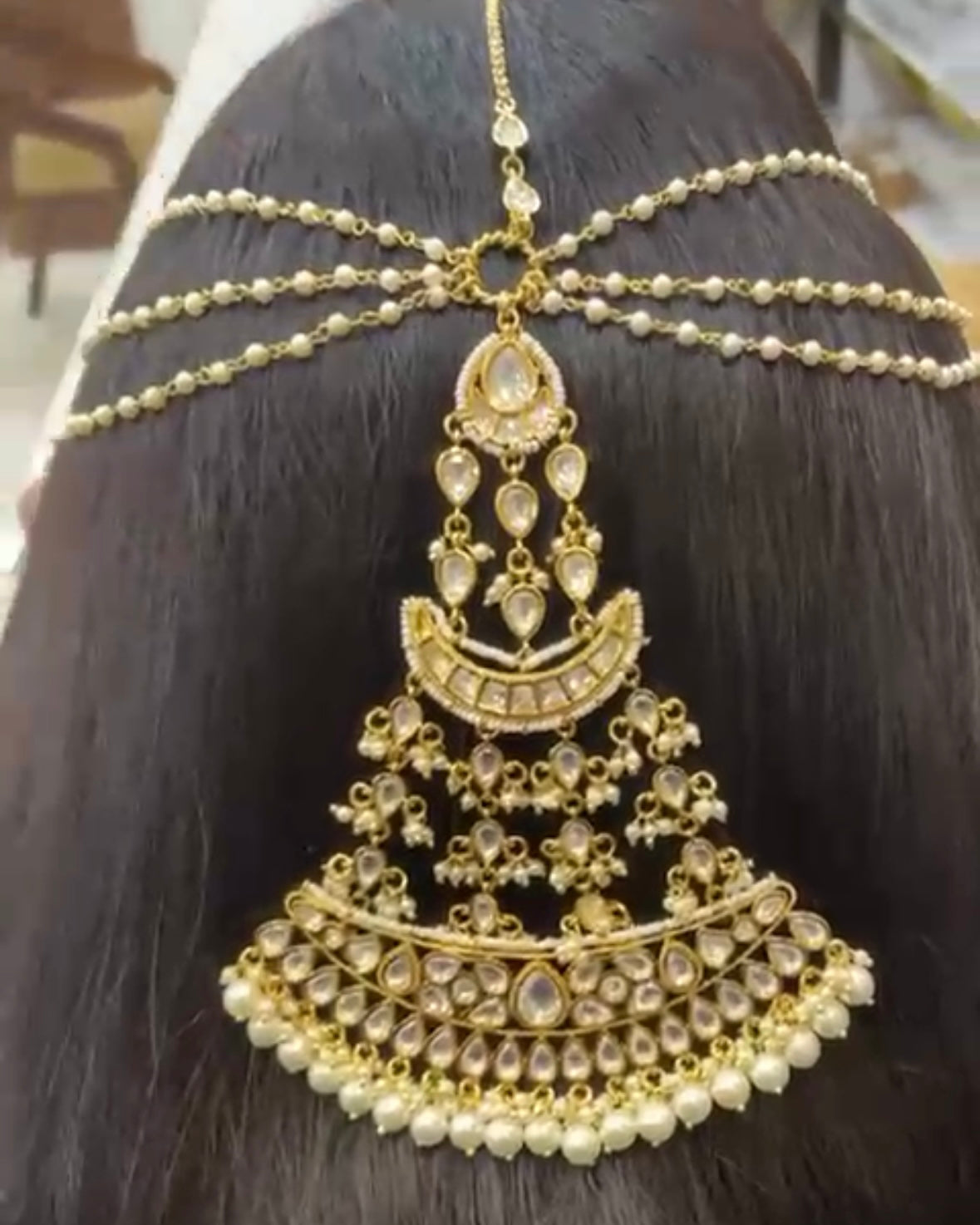 Close-up of kundan stone detailing and chain design in matha patti