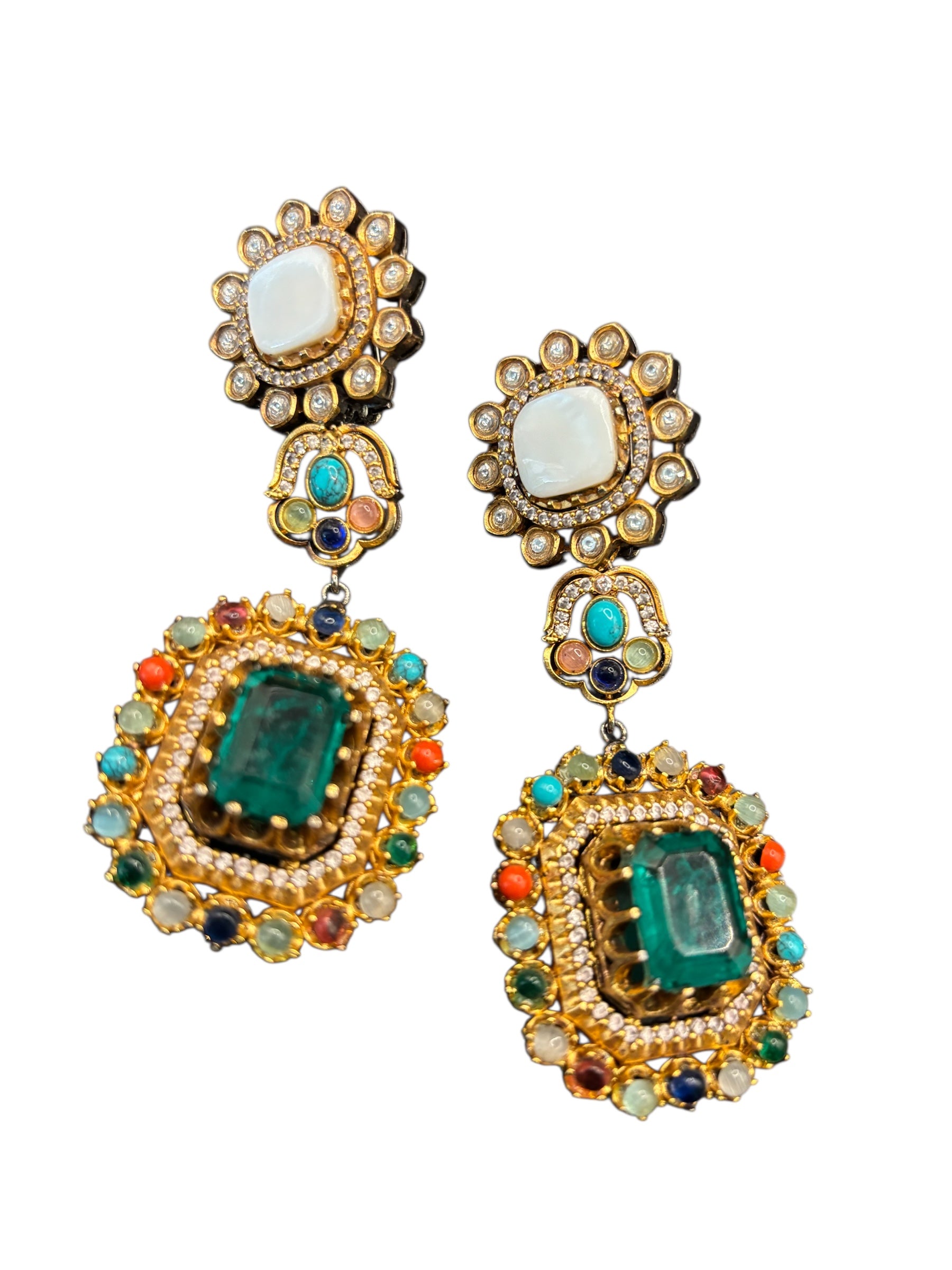 Close-up of enamel work and emerald-style centerpiece on luxury necklace