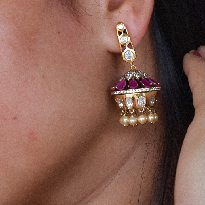 Close-up of ethnic kundan earrings with ruby stones and oxidised Victorian finish