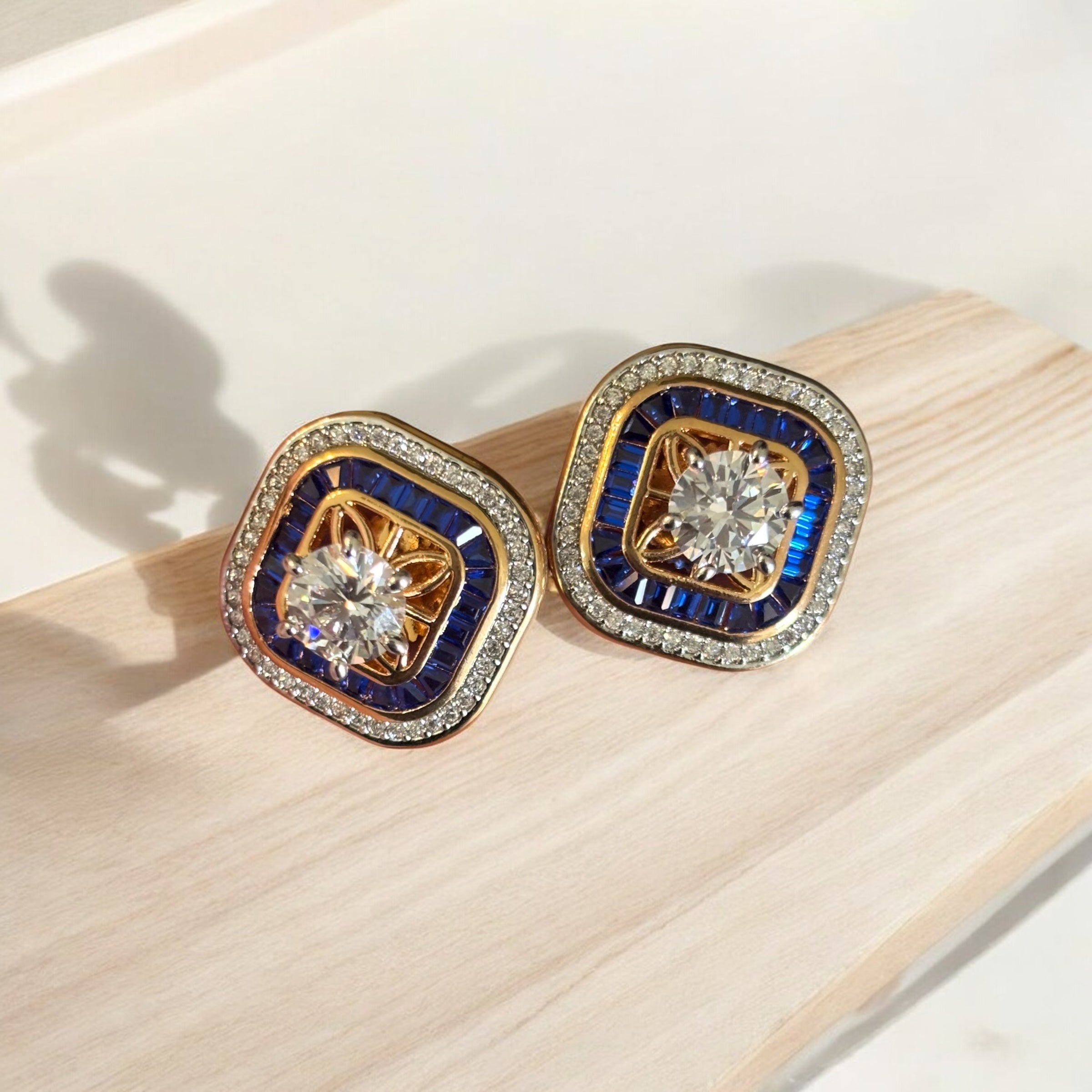 Diamond earrings with central stone and double halo of baguette and round-cut stones