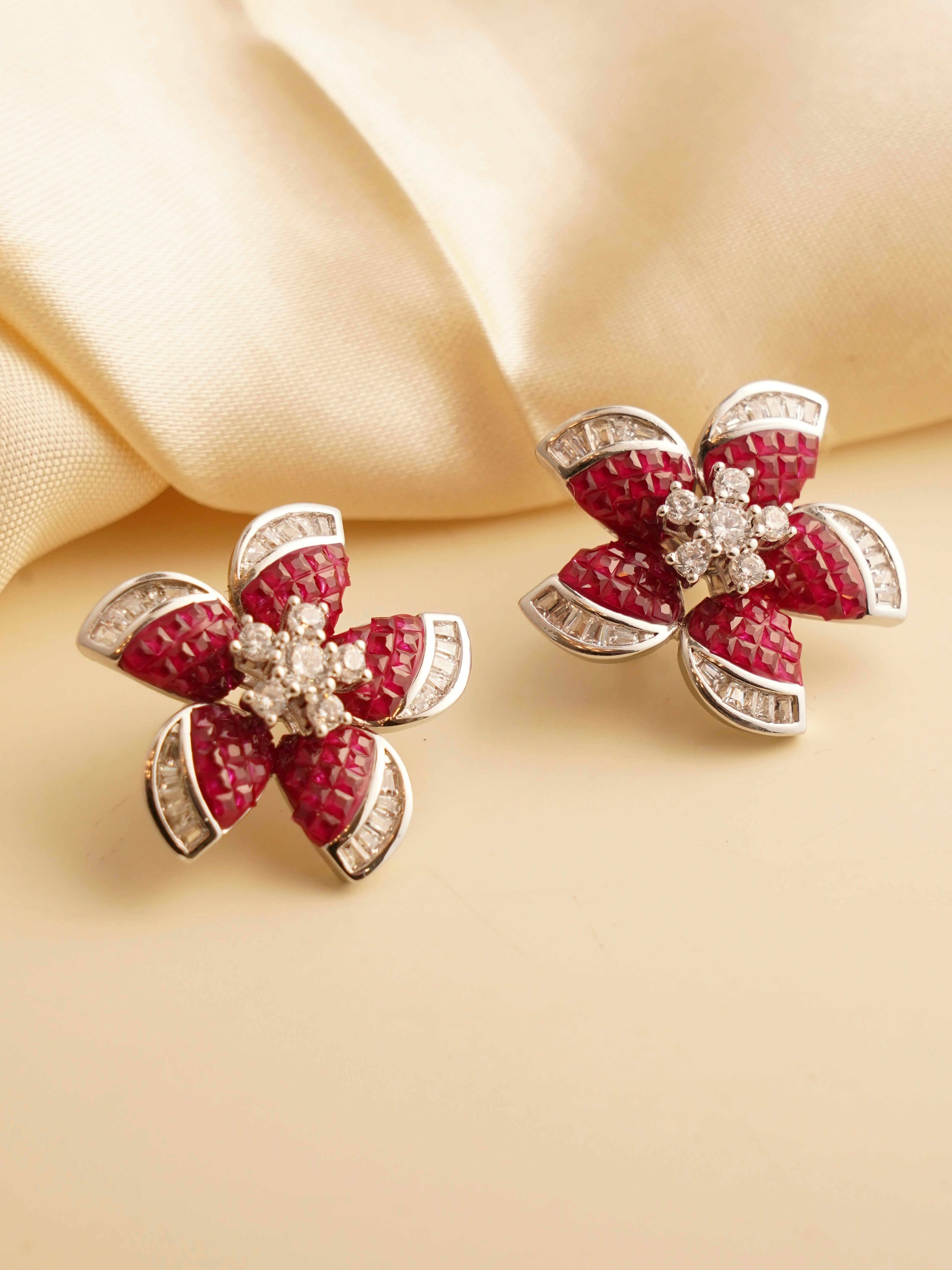 Rhodium plated ruby earrings in invisible setting with polished finish