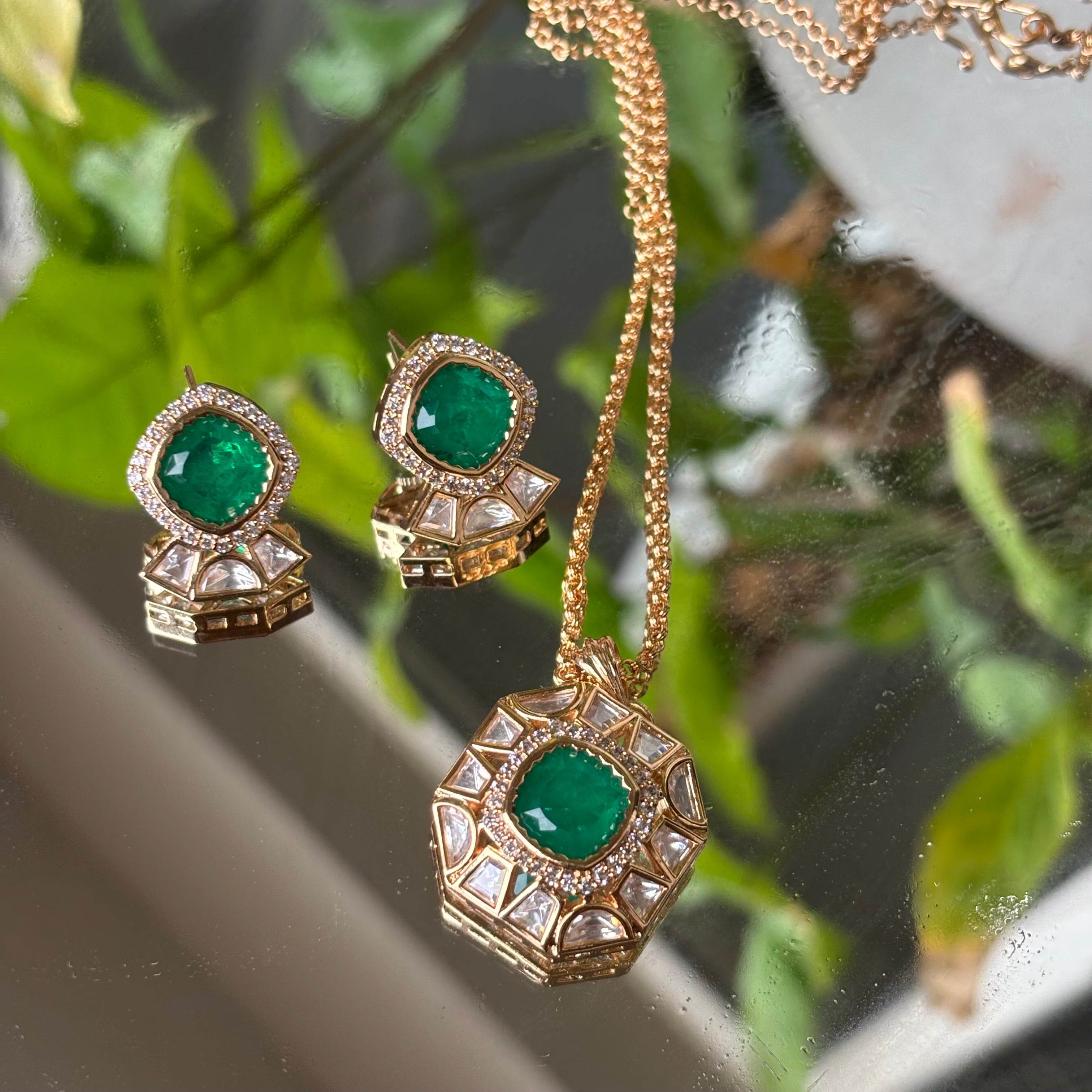 Close-up of vintage-style pendant with deep red stone and textured gold accents