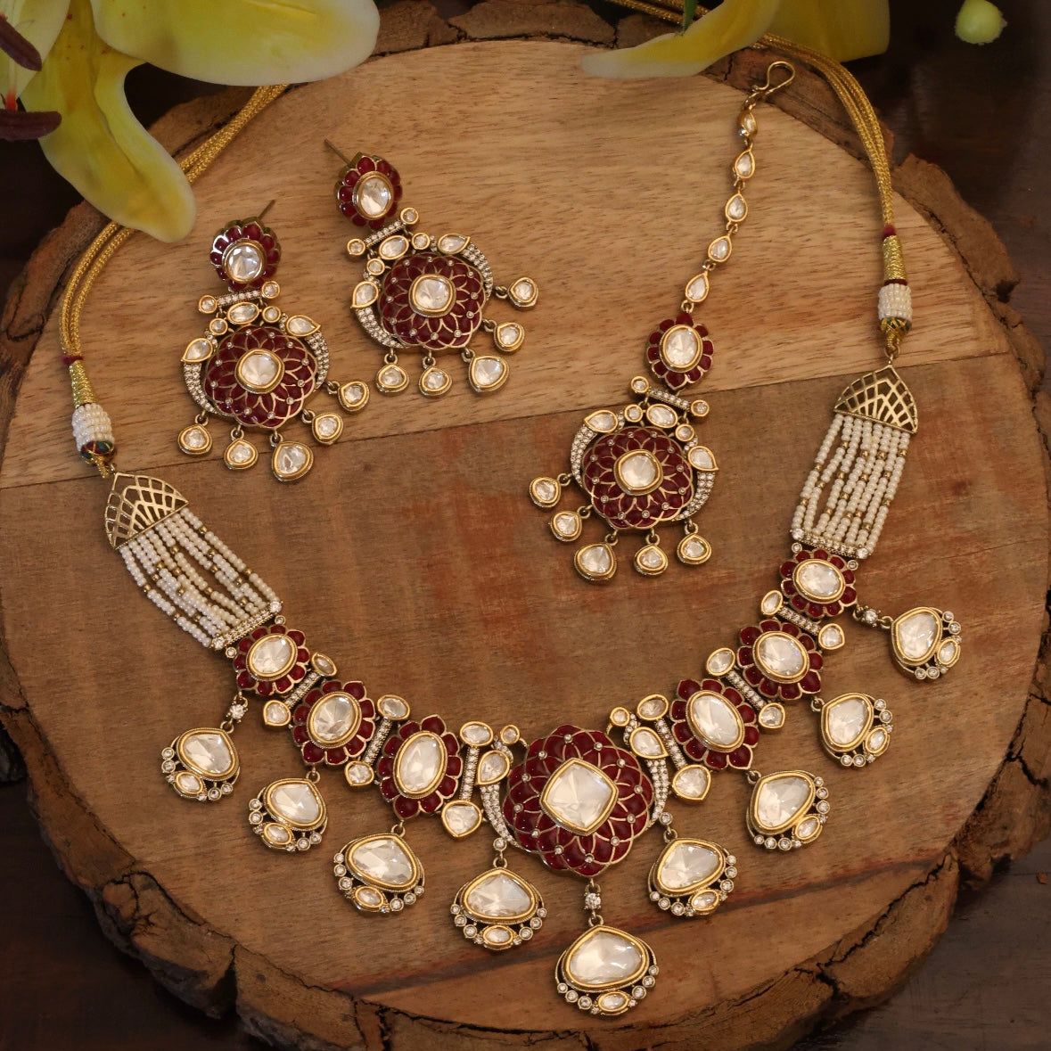 Close-up of polki necklace pendant with deep green accents and cascading pearls