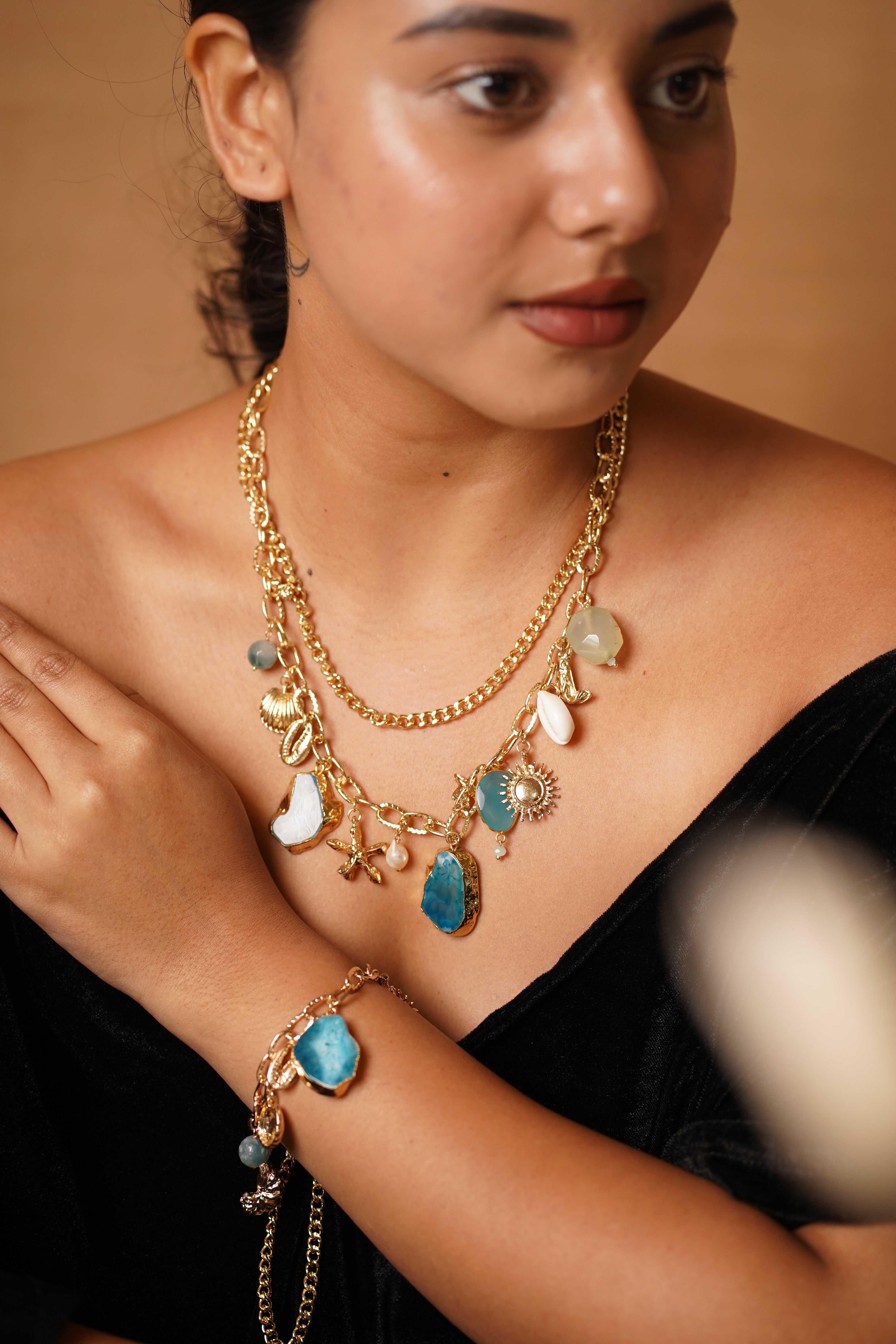 Back view of marine charm necklace highlighting beaded chain and clasp