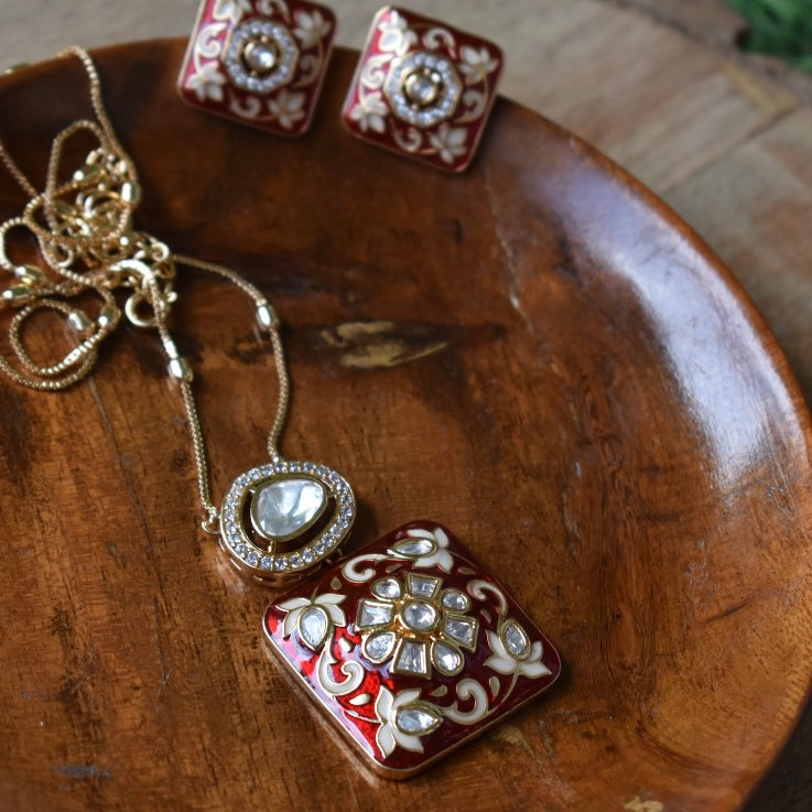 Full view of necklace and earrings set with enamel detailing and elegant craftsmanship
